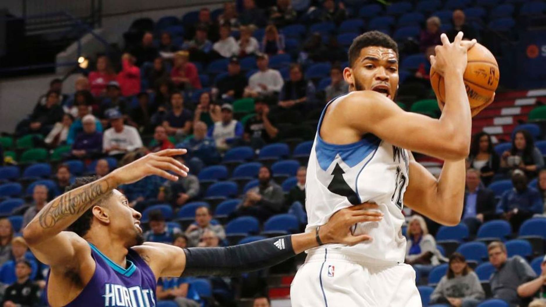 Minnesota Timberwolves' Karl-Anthony Towns, right, out jumps Charlotte Hornets' Christian Wood for a rebound in the first quarter of an NBA preseason basketball game Friday, Oct. 21, 2016, in Minneapolis. (AP Photo/Jim Mone)