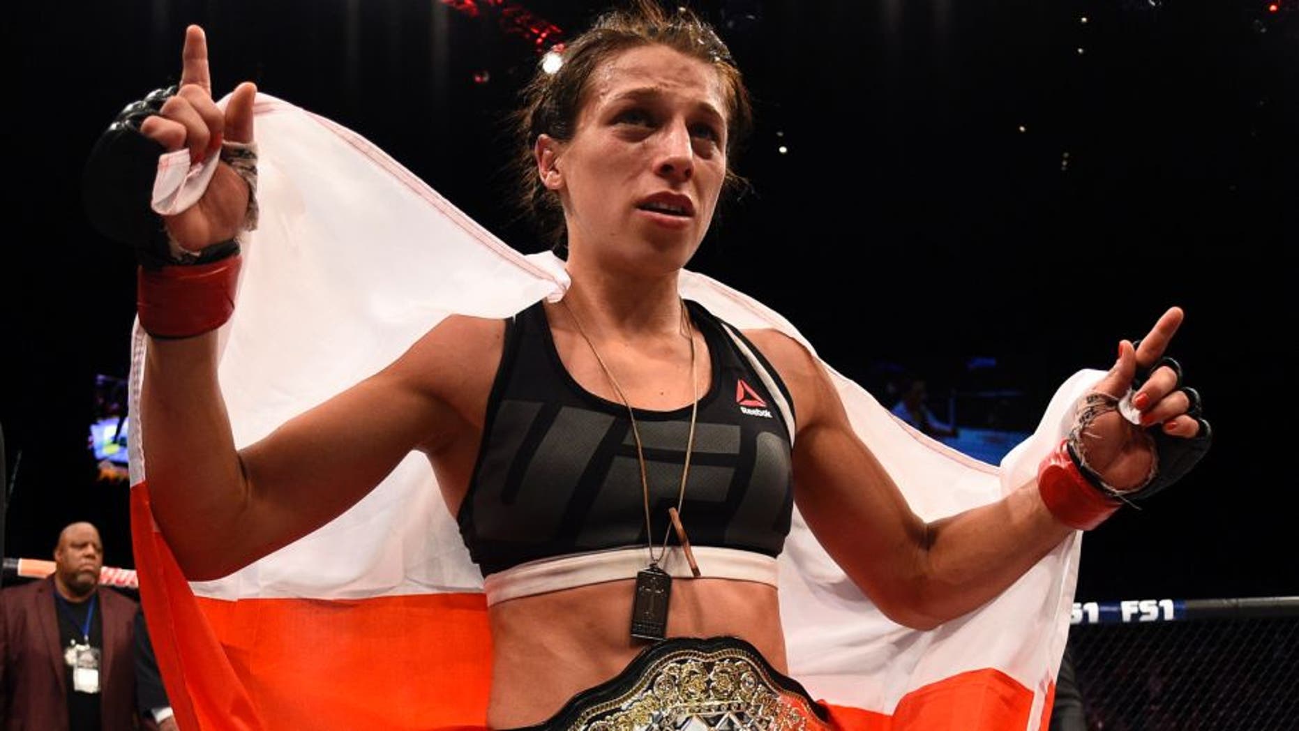LAS VEGAS, NV - JULY 08: Joanna Jedrzejczyk of Poland celebrates after her decision victory over Claudia Gadelha of Brazil in their women's strawweight championship bout during The Ultimate Fighter Finale event at MGM Grand Garden Arena on July 8, 2016 in Las Vegas, Nevada. (Photo by Jeff Bottari/Zuffa LLC/Zuffa LLC via Getty Images)