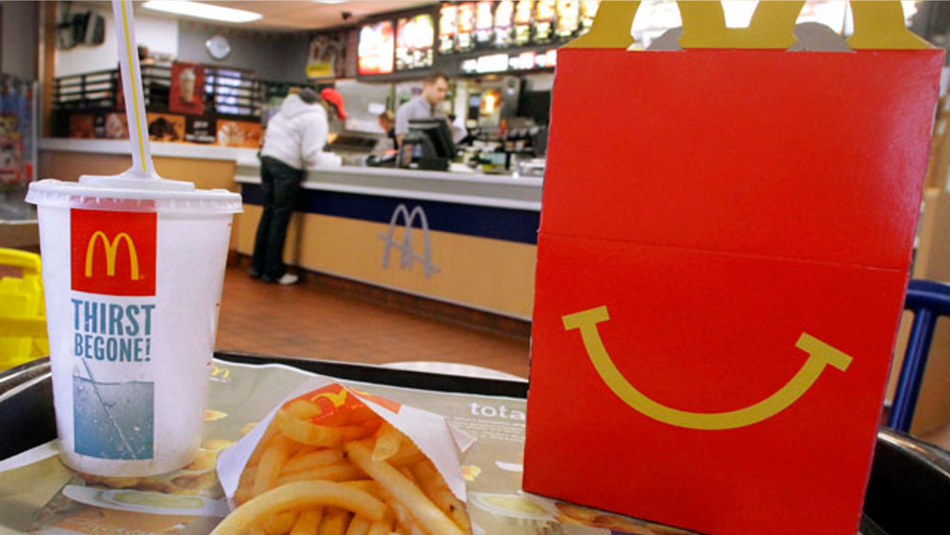 In this Jan. 20, 2012 photo, the McDonald's logo and a Happy Meal box with french fries and a drink are posed at McDonald's, in Springfield, Ill. McDonalds Corp. saw net income jump by 11 percent in the fourth quarter, as the fast-food giant continued to attract budget-conscious customers with low prices. (AP Photo/Seth Perlman)