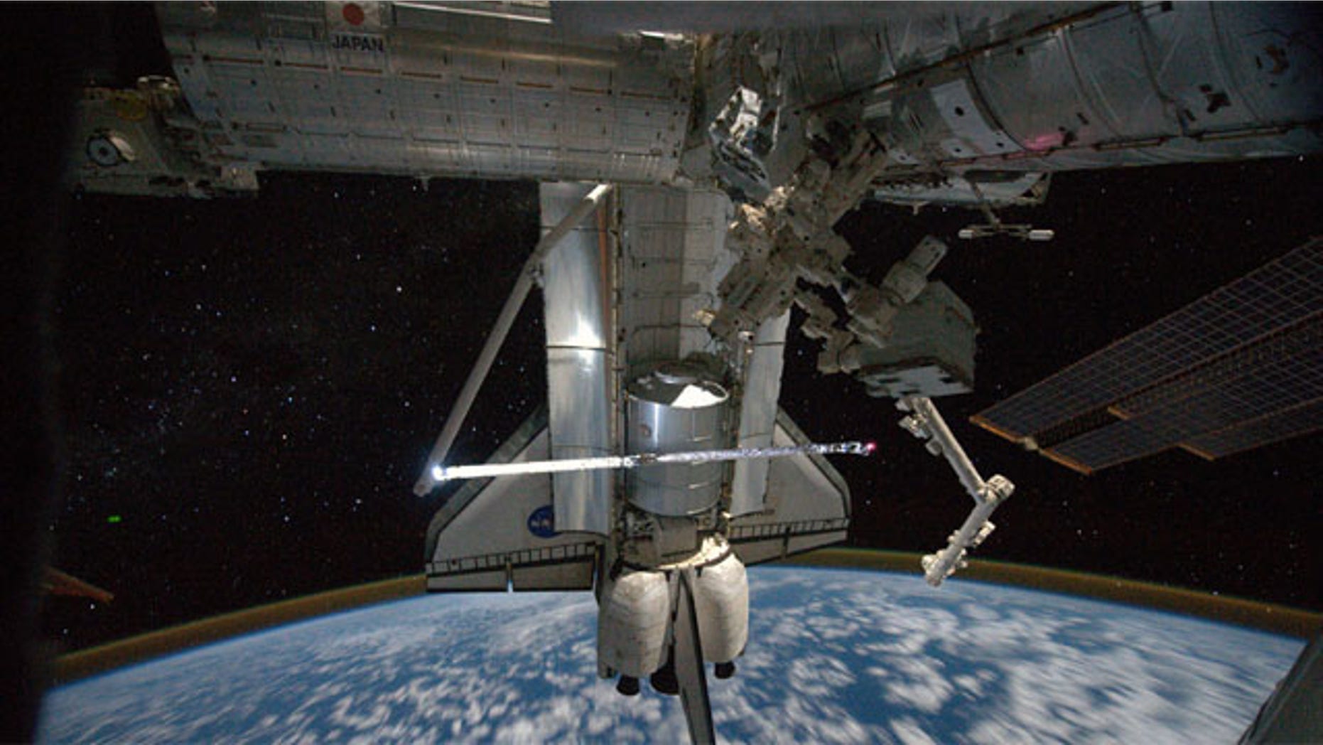 This view of the space shuttle Atlantis while still docked with the International Space Station was taken by a crew member aboard the station on the final day of joint activities between the crew members for the STS-135 and Expedition 28 missions.