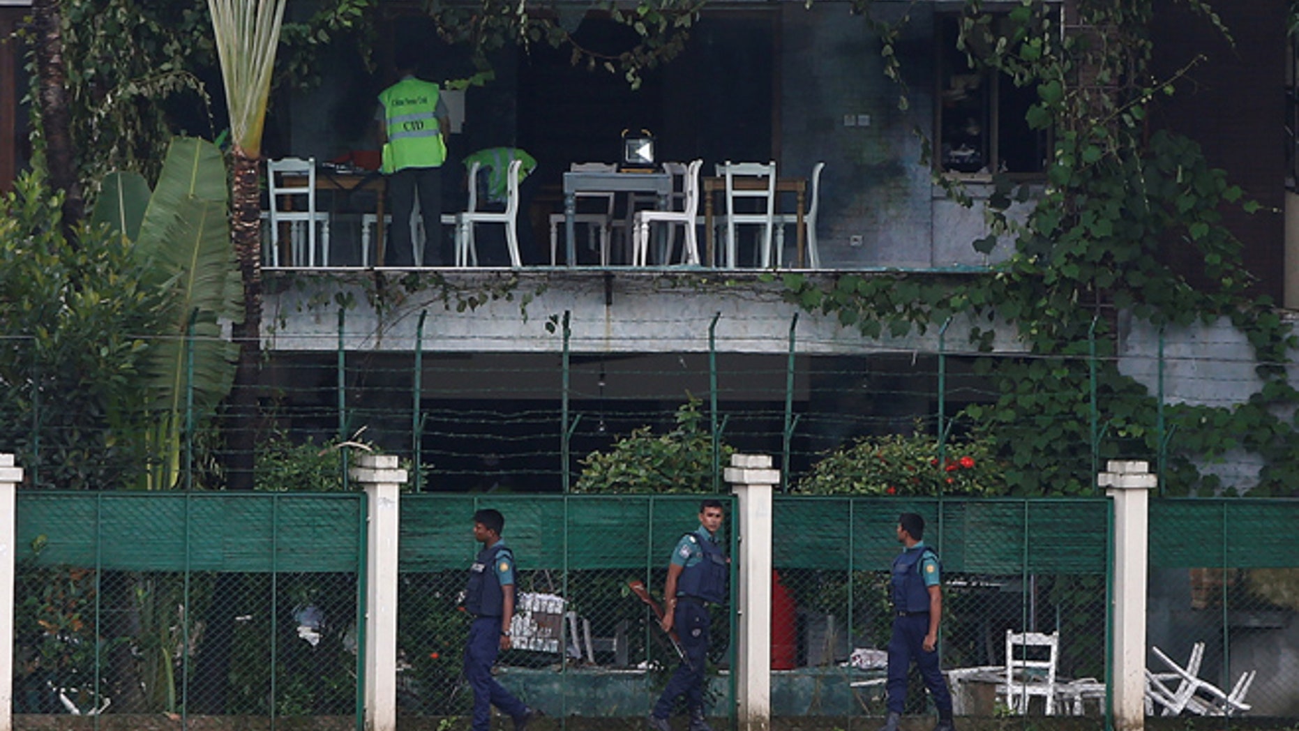 July 3: Policemen patrol outside the Holey Artisan Bakery and the O'Kitchen Restaurant as others inspect the site after gunmen attacked, in Dhaka, Bangladesh