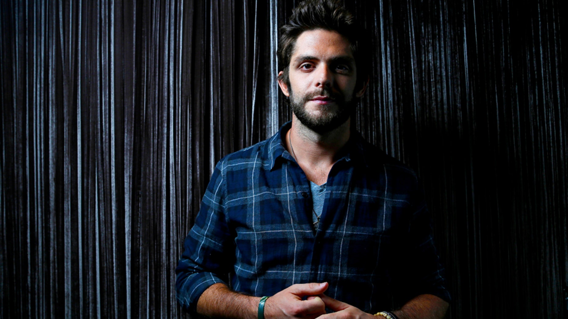 In this Sept. 15, 2015 file photo, country singer Thomas Rhett poses for a photo at Sinema Restaurant & Bar in Nashville, Tenn.