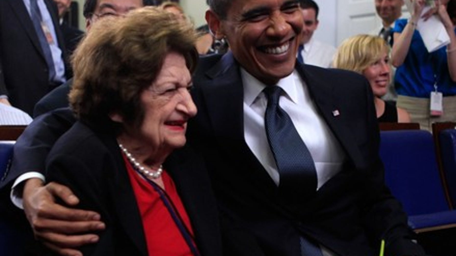 Aug. 4, 2009: President Obama mugs for the camera with Hearst White House columnist Helen Thomas during a mutual birthday celebration in the White House briefing room. (Reuters)