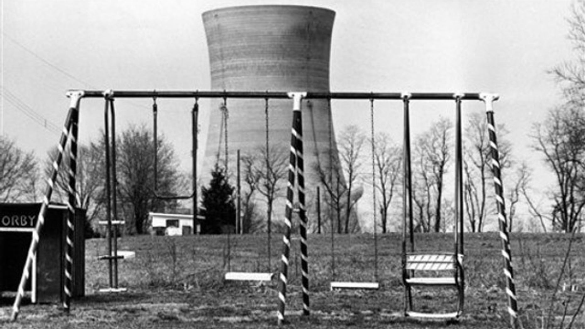 This file photo from March 30, 1979 shows a cooling tower of the Three Mile Island nuclear power plant near Harrisburg, Pa. , as it looms behind an abandoned playground. The partial meltdown at Three Mile Island nuclear plant in 1979 routed more than 180,000 people living within 50 miles of the plant, a five-day evacuation nightmare that residents are reliving as the nuclear plant crisis unfolds in Japan (AP).