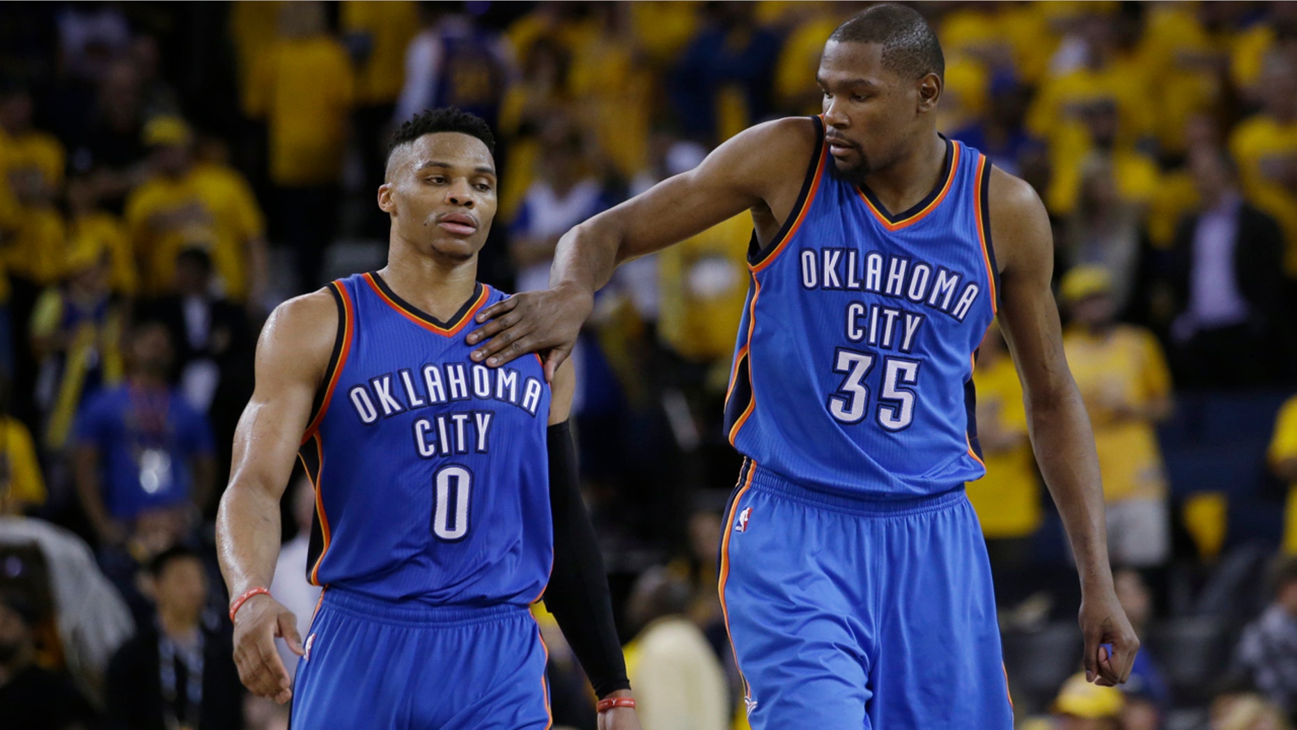 May 16, 2016: Kevin Durant (35) pats Oklahoma City Thunder teammate Russell Westbrook (0) on the shoulder as they take a lead over the Golden State Warriors during the second half of Game 1 of the NBA Western Conference final.