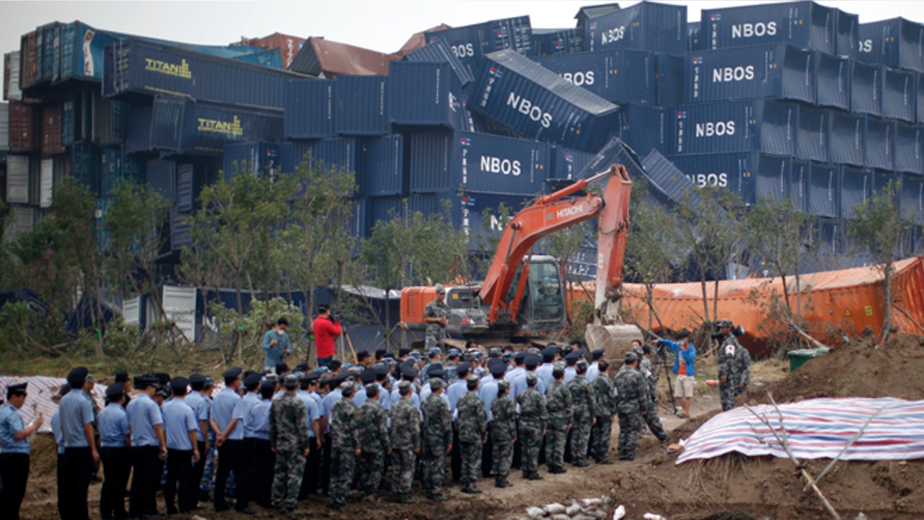 Aug. 18, 2015: Chinese soldiers, policemen and paramilitary policemen attend a memorial service for victims of the Tianjin blasts near the disaster's epicenter in northeastern China's Tianjin municipality.