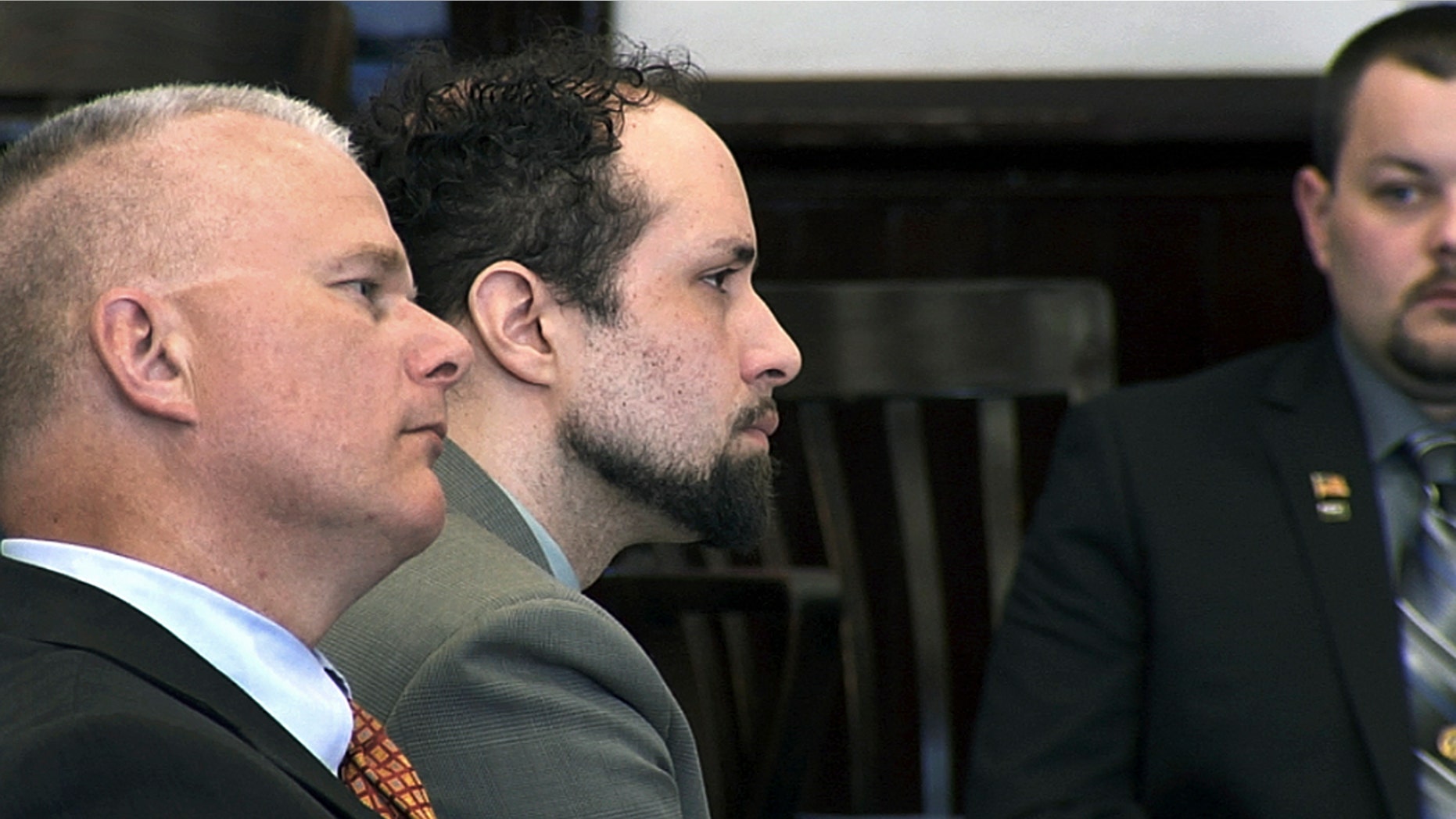 Luc Tieman, center, and his lawyer Stephen Smith, left, listen inside a courtroom where Tieman was sentenced to 55 years, Friday, May 11, 2018, in Somerset County Superior Court in Skowhegan, Maine.