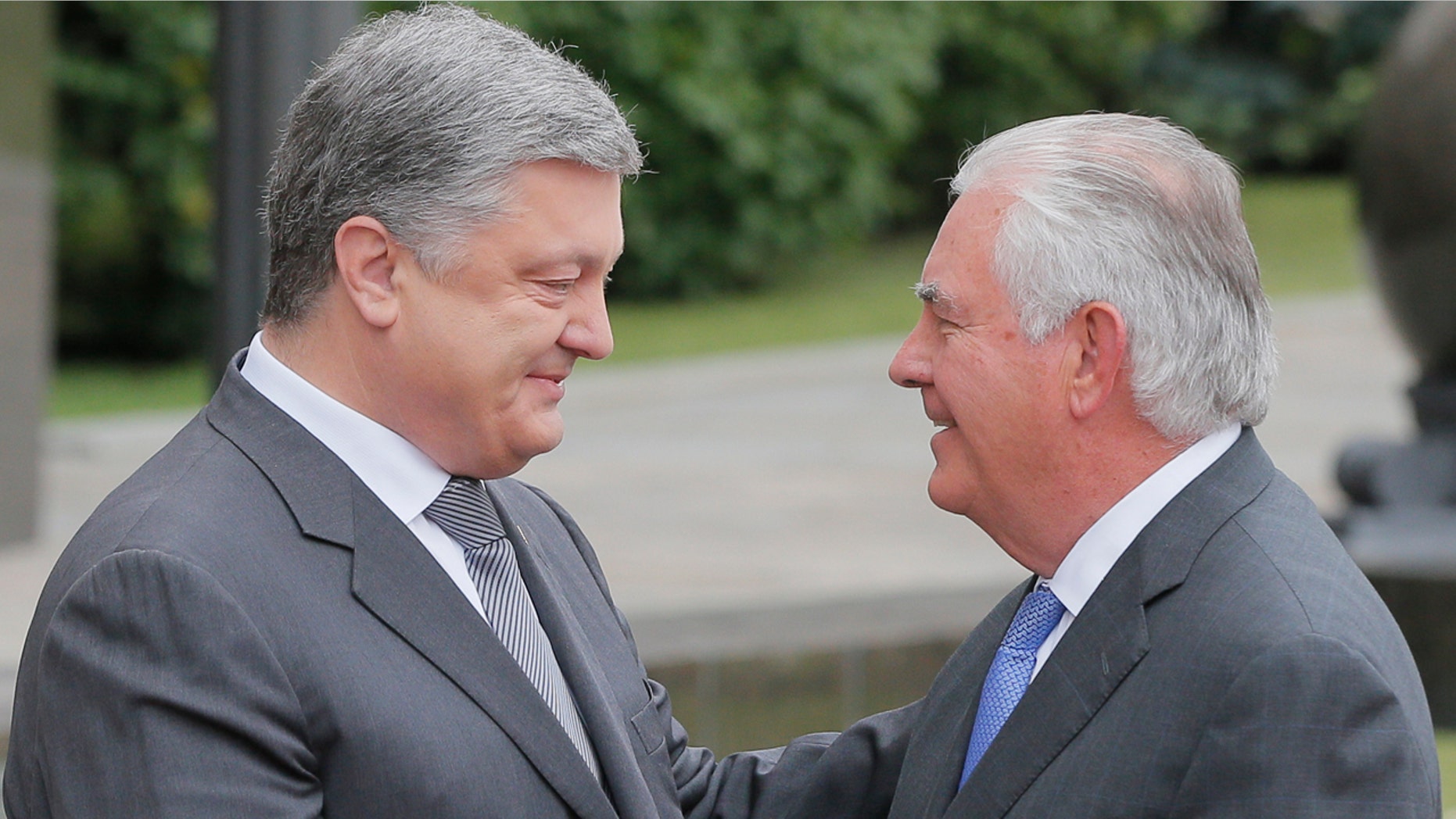 Ukrainian President Petro Poroshenko, left, and U.S. Secretary of State Rex Tillerson shakes hands before a meeting in Kiev, Sunday, July 9, 2017.