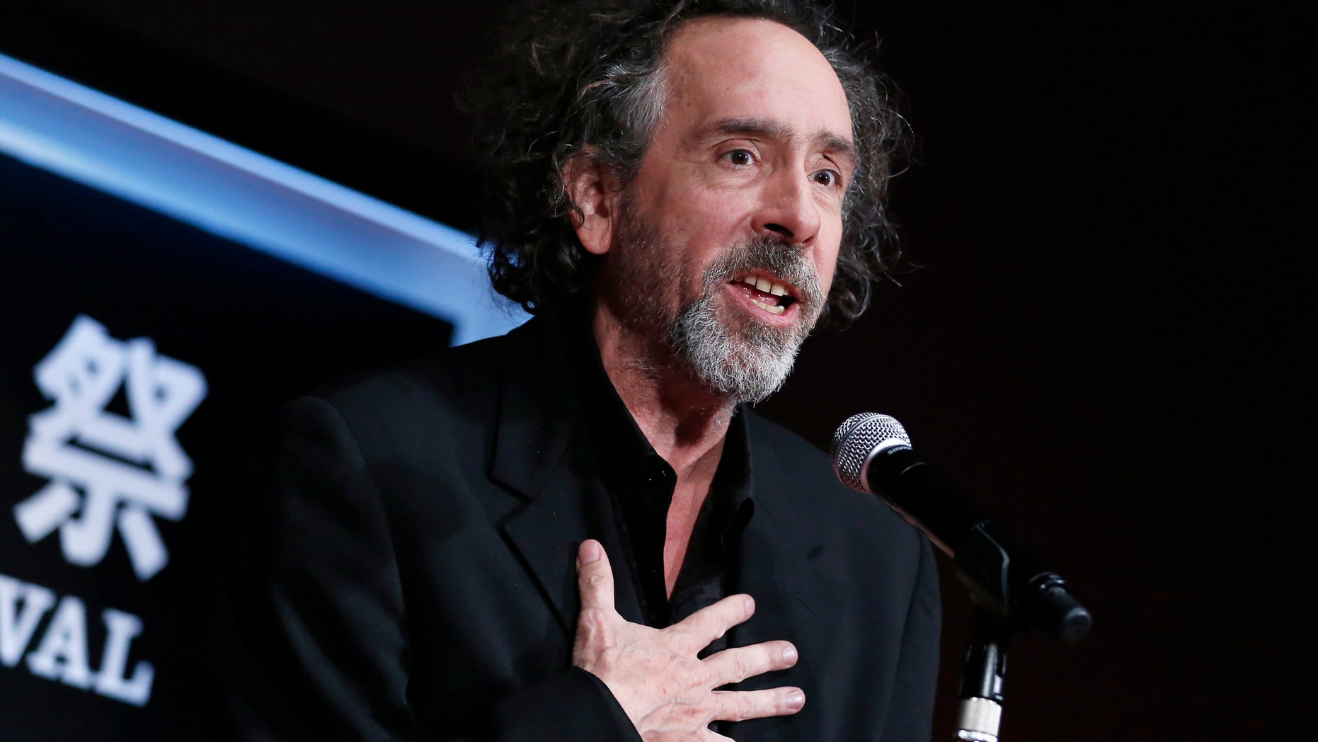 Director Tim Burton speaks as he receives the SAMURAI award during the closing ceremony of the Tokyo International Film Festival in Tokyo October 31, 2014. REUTERS/Yuya Shino (JAPAN - Tags: ENTERTAINMENT SOCIETY) - RTR4CATP