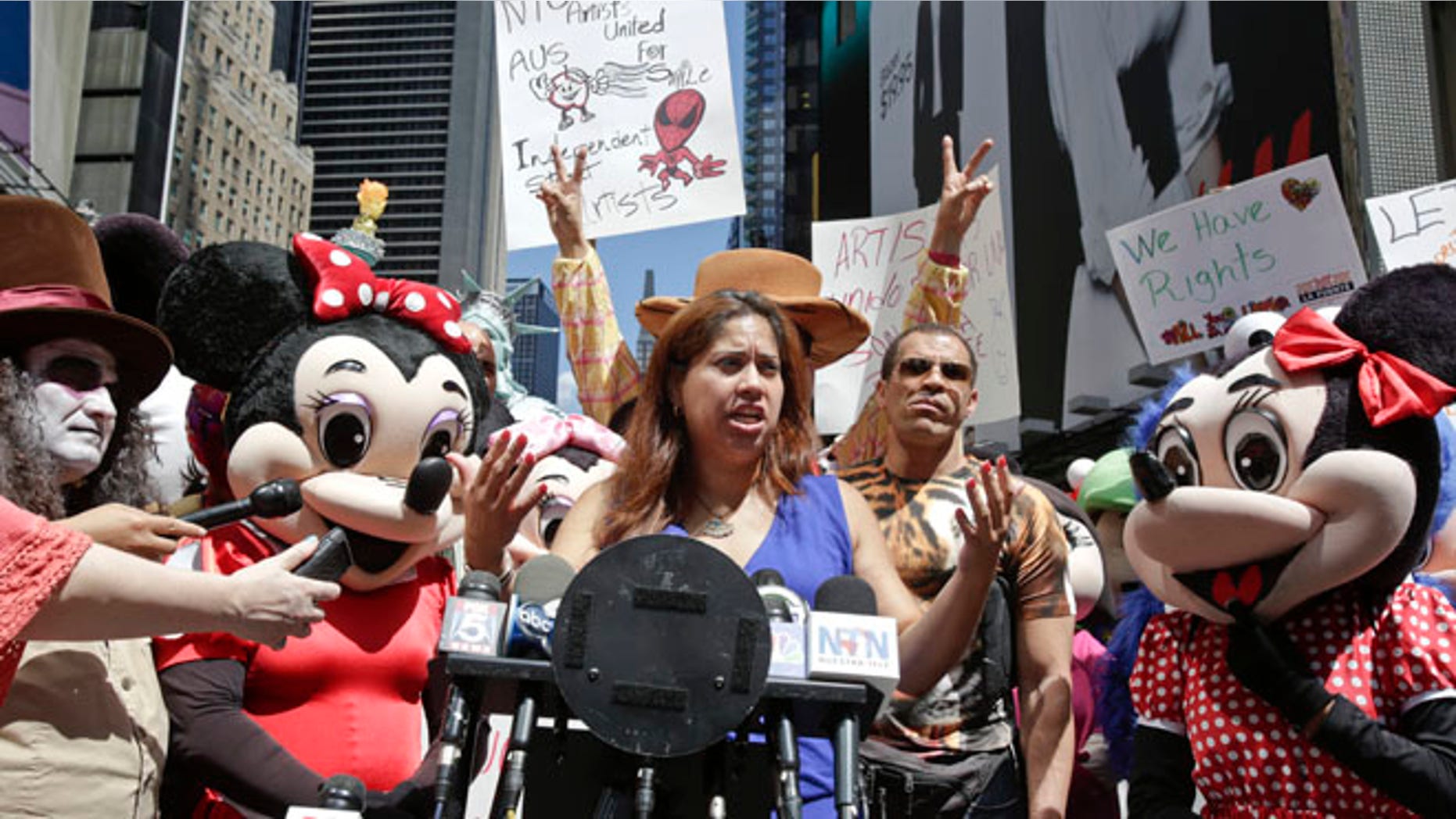 Aug 19, 2014: Lucia Gomez, center, executive director of La Fuente, speaks during a press conference at Times Square in New York.