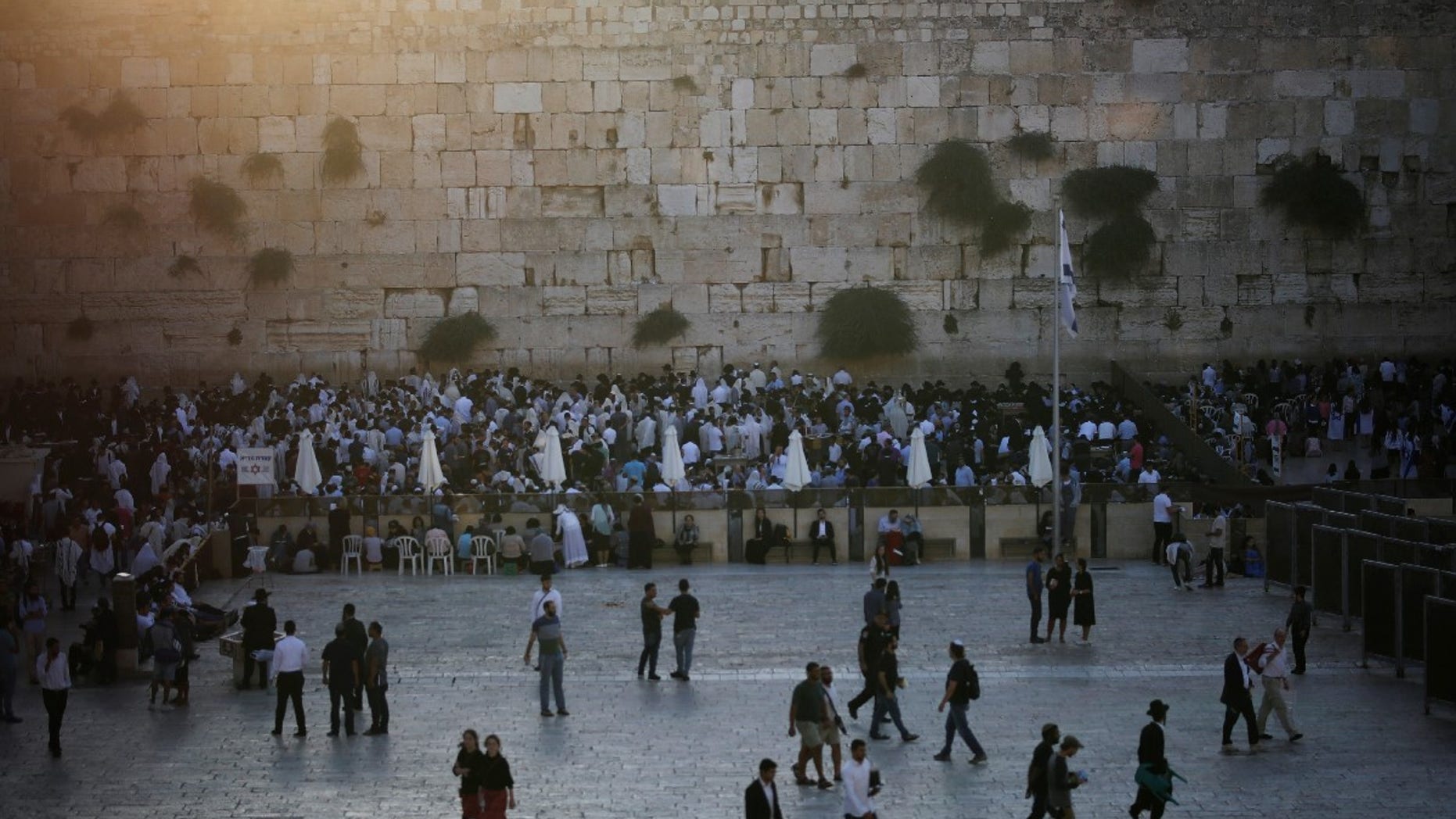 Jewish worshipers pray in front of the Western Wall on Tisha B'Av, a day of fasting and lament, in Jerusalem's Old City August 1, 2017.