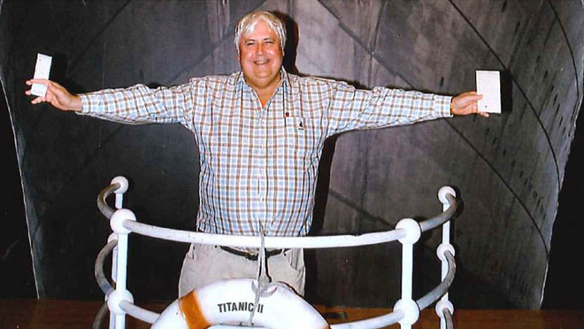 In this April 25, 2012 photo provided by Crook Publicity, Australian billionaire Clive Palmer poses in front of an artist impression of the Titanic ll at MGM Studios in Los Angeles, Ca. Palmer said Monday, April 30, 2012, that he'll build a high-tech replica of the Titanic at a Chinese shipyard and its maiden voyage in late 2016 will be from England to New York, just like its namesake planned.