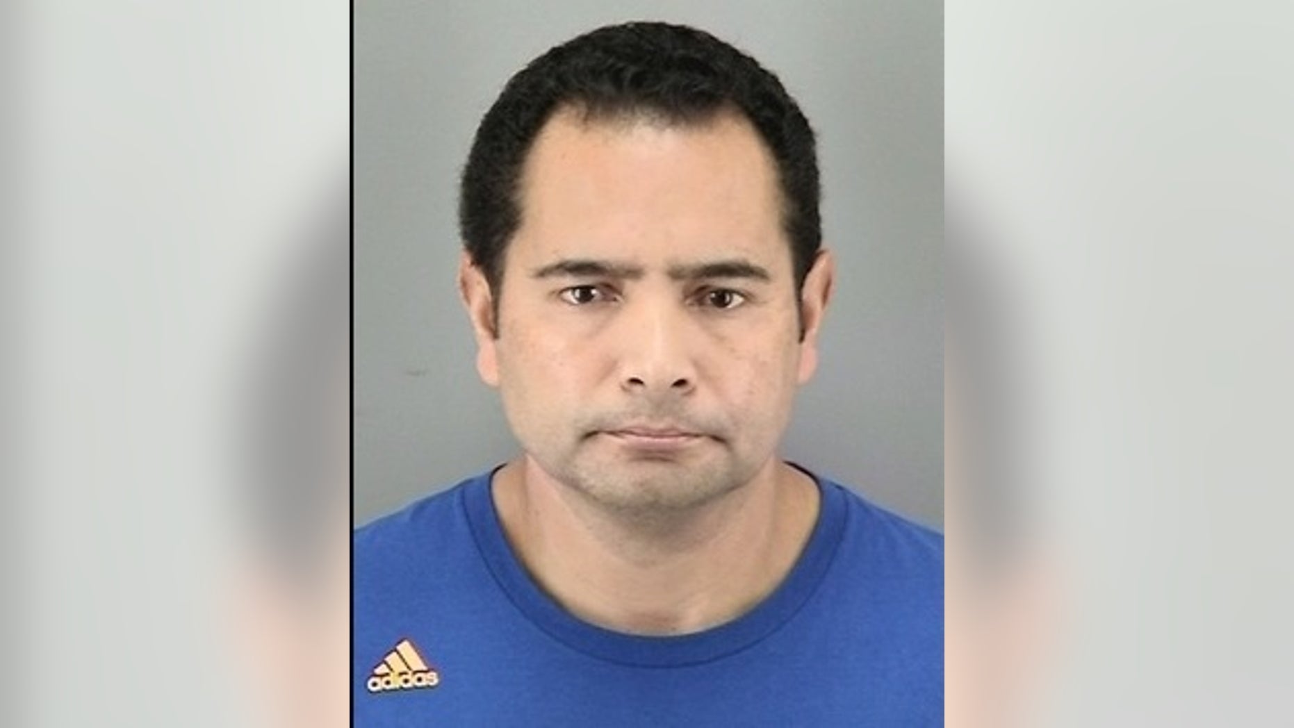 Andres Tobar was accused of dangling a student from a second-floor window.