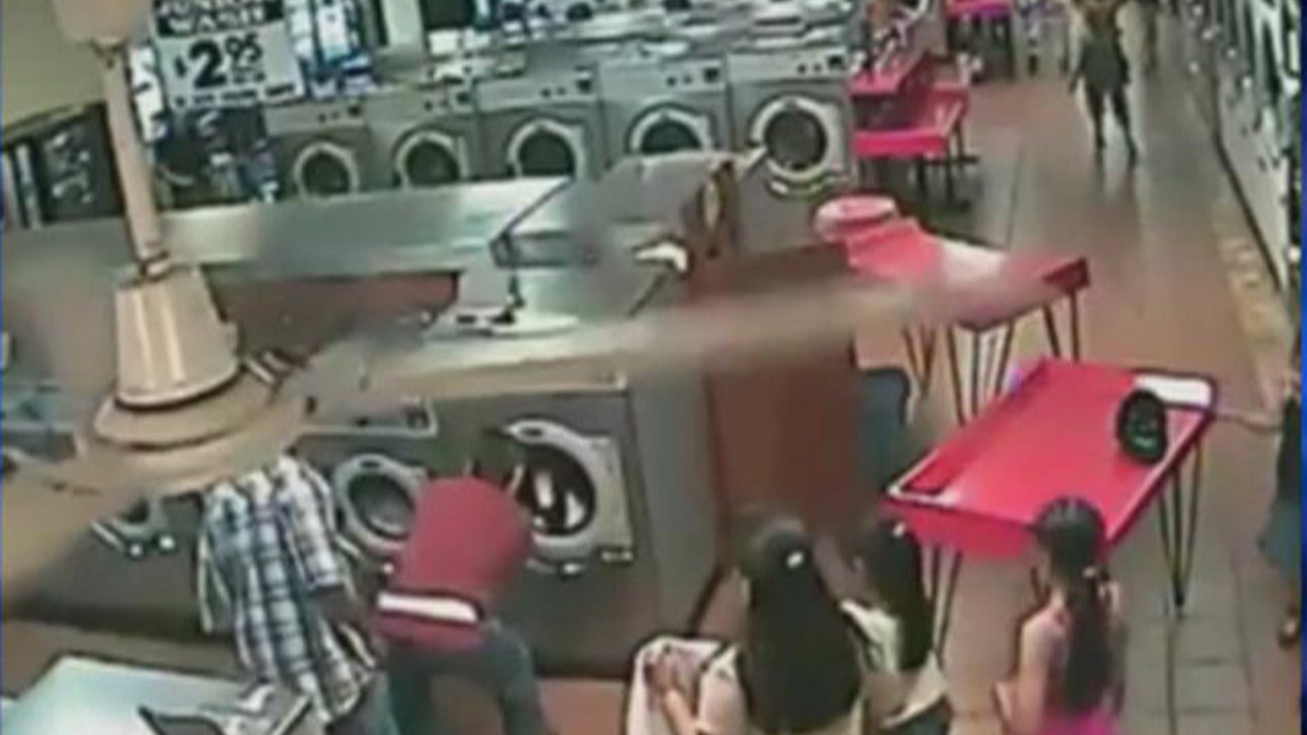A local laundromat's surveillance video shows a small child loaded into a washing machine.