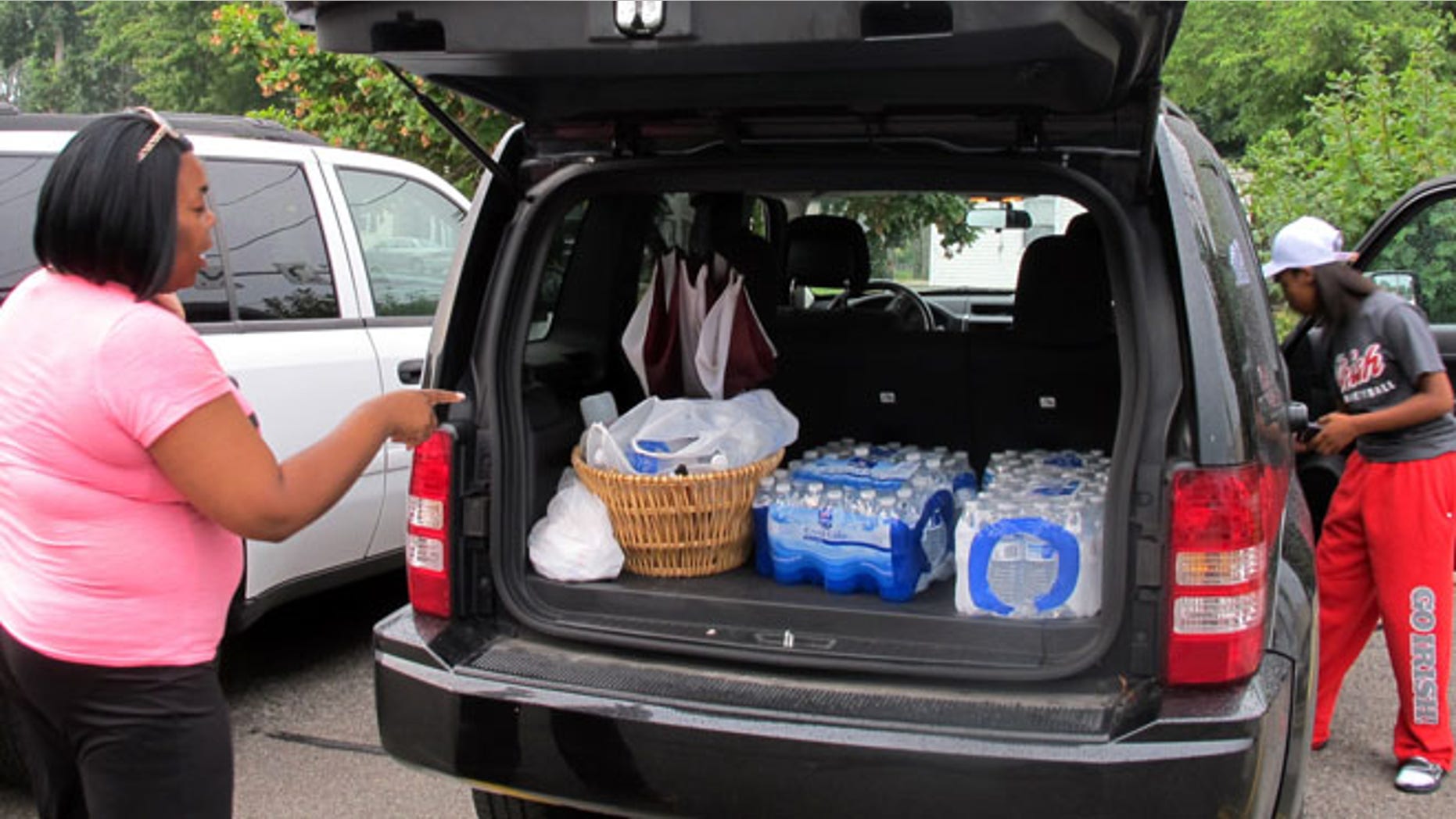 Aug 2, 2014: Aundrea Simmons stands next to her minivan with cases of bottled water she bought after Toledo warned residents not to use its water in Toledo, Ohio.