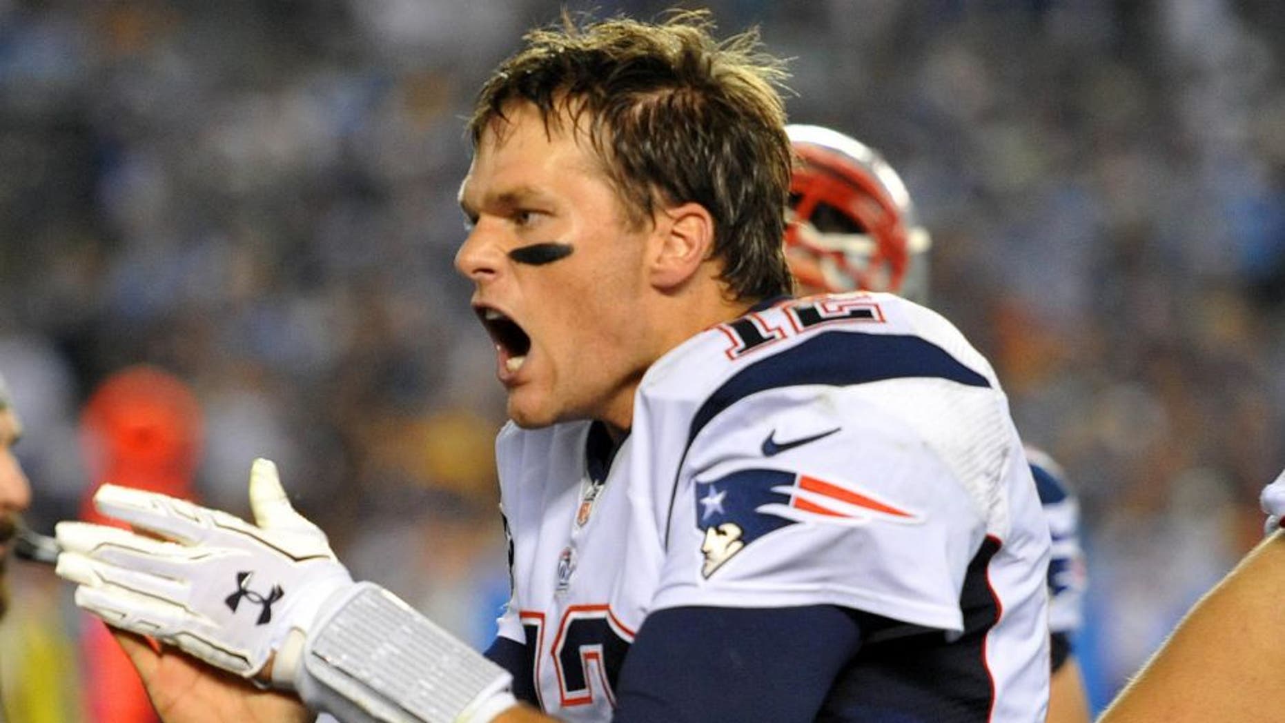 Dec 7, 2014; San Diego, CA, USA; New England Patriots quarterback Tom Brady (12) reacst on the sideline against the San Diego Chargers during the fourth quarter at Qualcomm Stadium. Mandatory Credit: Jake Roth-USA TODAY Sports