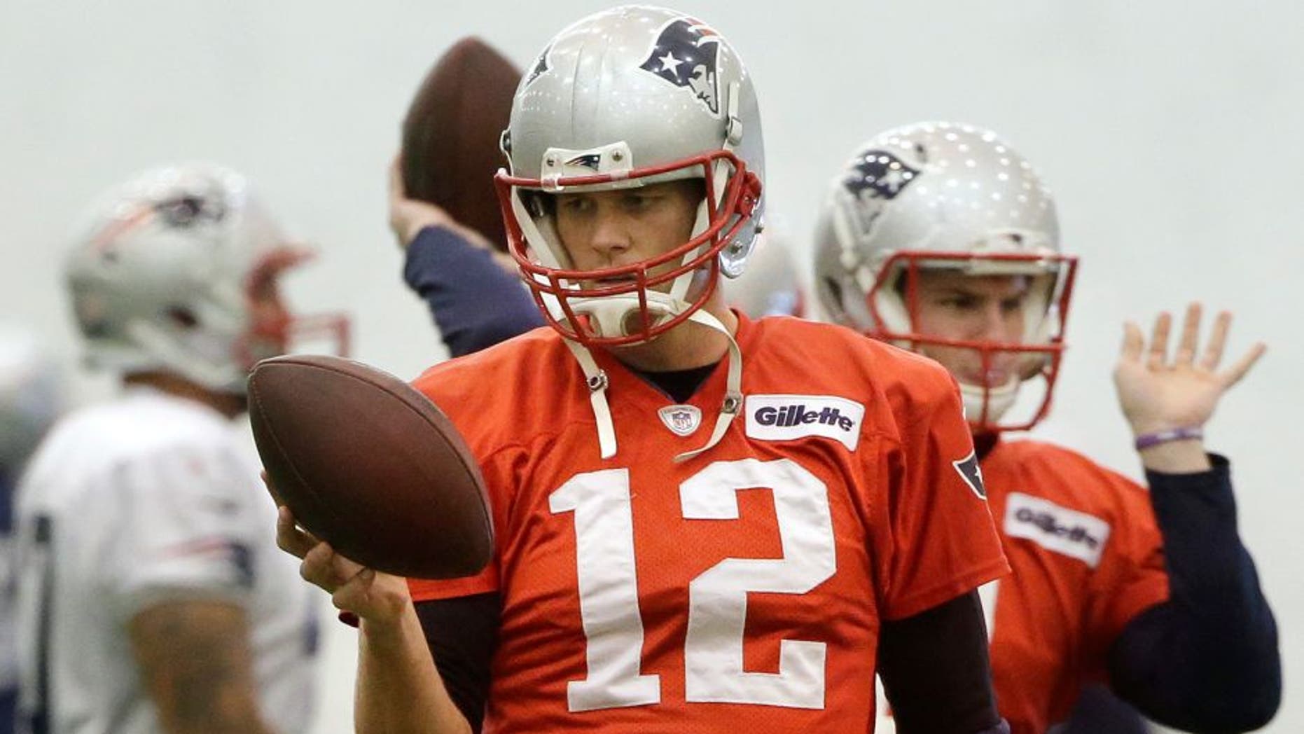 New England Patriots quarterback Tom Brady (12) holds a football during NFL football practice, Sunday, Jan. 25, 2015, in Foxborough, Mass. The Patriots are to face the Seattle Seahawks in Super Bowl XLIX, Sunday, Feb. 1, in Glendale, Ariz. (AP Photo/Steven Senne)