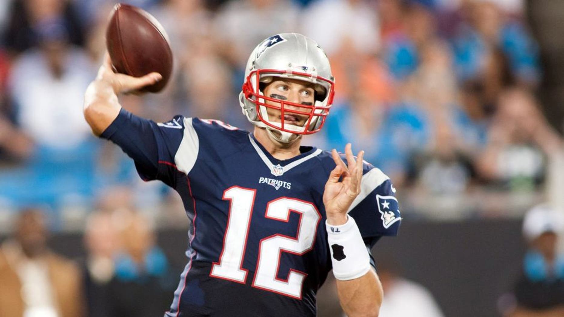 Aug 28, 2015; Charlotte, NC, USA; New England Patriots quarterback Tom Brady (12) passes the ball during the second quarter against the Carolina Panthers at Bank of America Stadium. Mandatory Credit: Jeremy Brevard-USA TODAY Sports