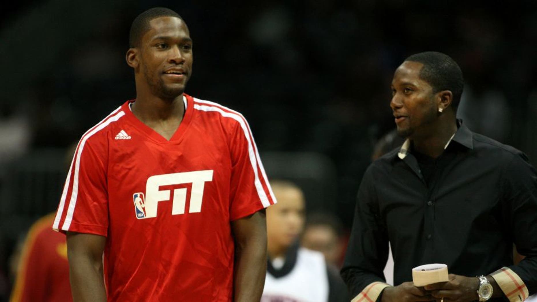 Jan 3, 2014; Atlanta, GA, USA; Golden State Warriors point guard Toney Douglas (0) talks to his brother and Atlanta Falcons wide receiver Harry Douglas before a game against the Atlanta Hawks at Philips Arena. Mandatory Credit: Brett Davis-USA TODAY Sports