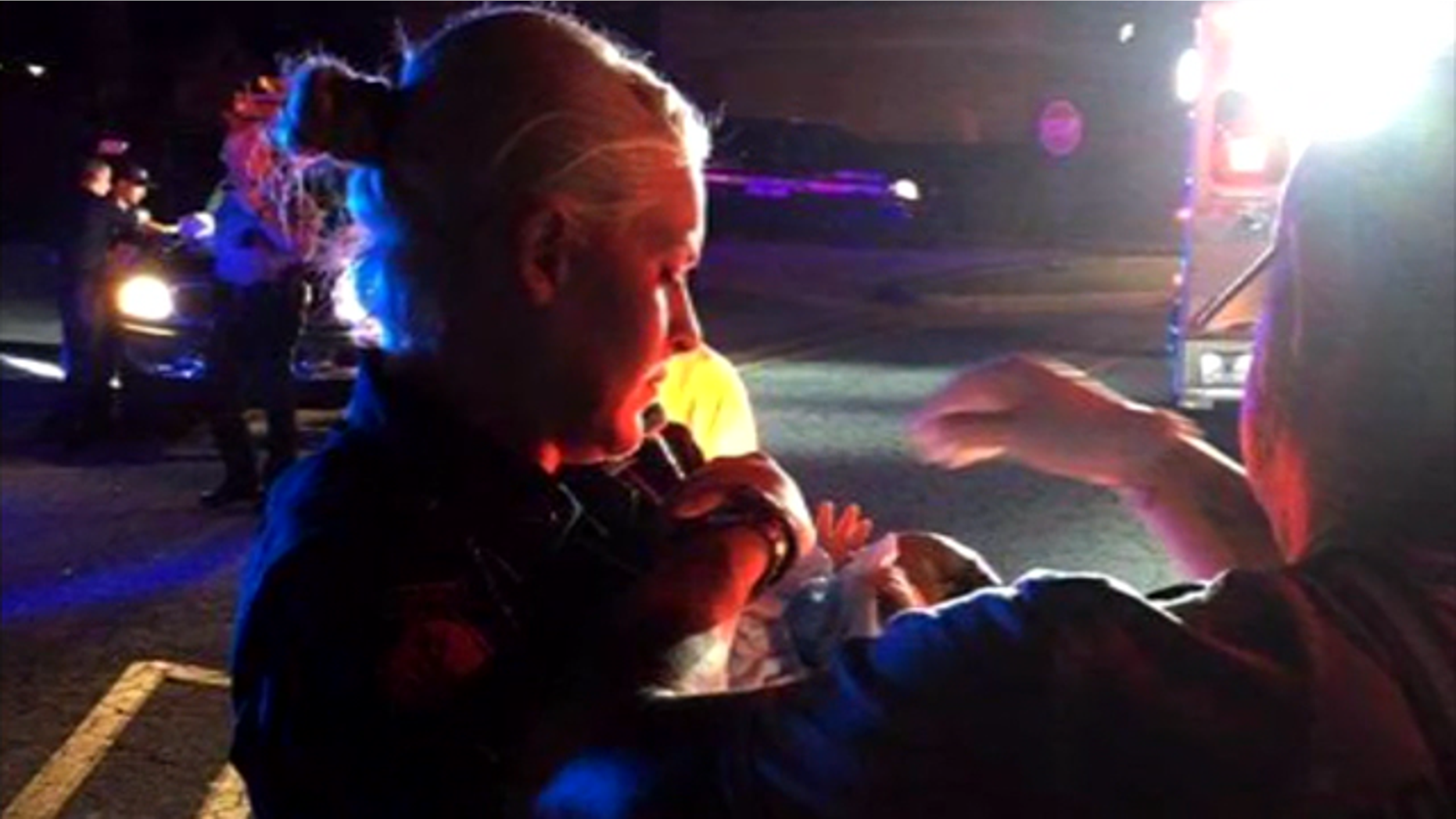 Officer Tongate holds baby Riley.