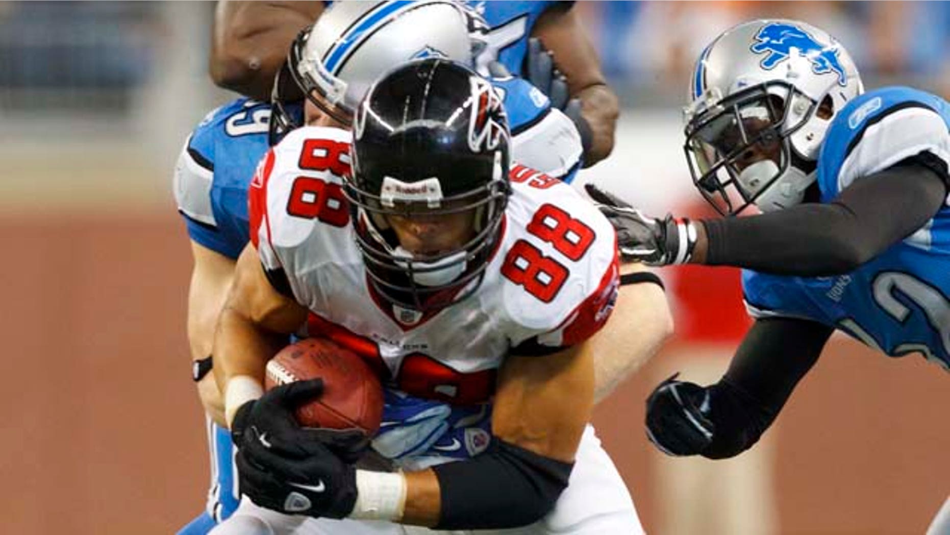 Atlanta Falcons tight end Tony Gonzalez (88) is tackled by Detroit Lions outside linebacker Bobby Carpenter (59), Amari Spievey, right, and linebacker Stephen Tulloch (55) in the third quarter of an NFL football game in Detroit, Sunday, Oct. 23, 2011. Gonzalez had five receptions for 62 yards to pass Marvin Harrison for second place on the NFL career receptions list. (AP Photo/Rick Osentoski)