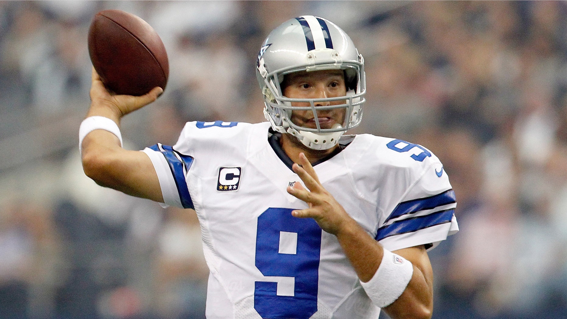 ARLINGTON, TX - SEPTEMBER 23: Tony Romo, of the Dallas Cowboys, looks for an open receiver against the Tampa Bay Buccaneers at Cowboys Stadium on September 23, 2012 in Arlington, Texas.