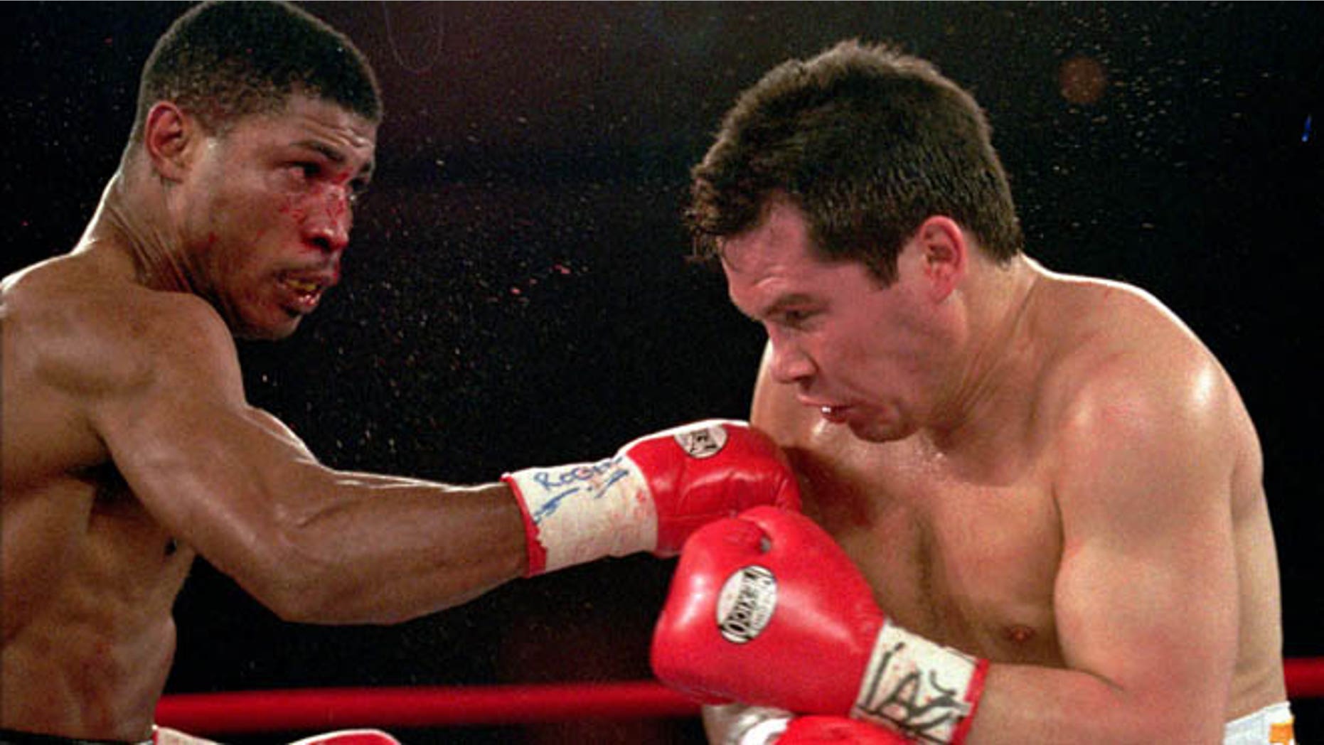 March, 29,1997: In this file photo, Tony Martin, left, of Philadelphia, punches Mexico's Julio Cesar Chavez in the second round of their Welterweight Special Attraction fight, in Las Vegas. Police say that Martin, a former welterweight, was fatally shot Friday, March 8, 2013, in an altercation with a visitor at one of his rental properties in Philadelphia. He was 52.