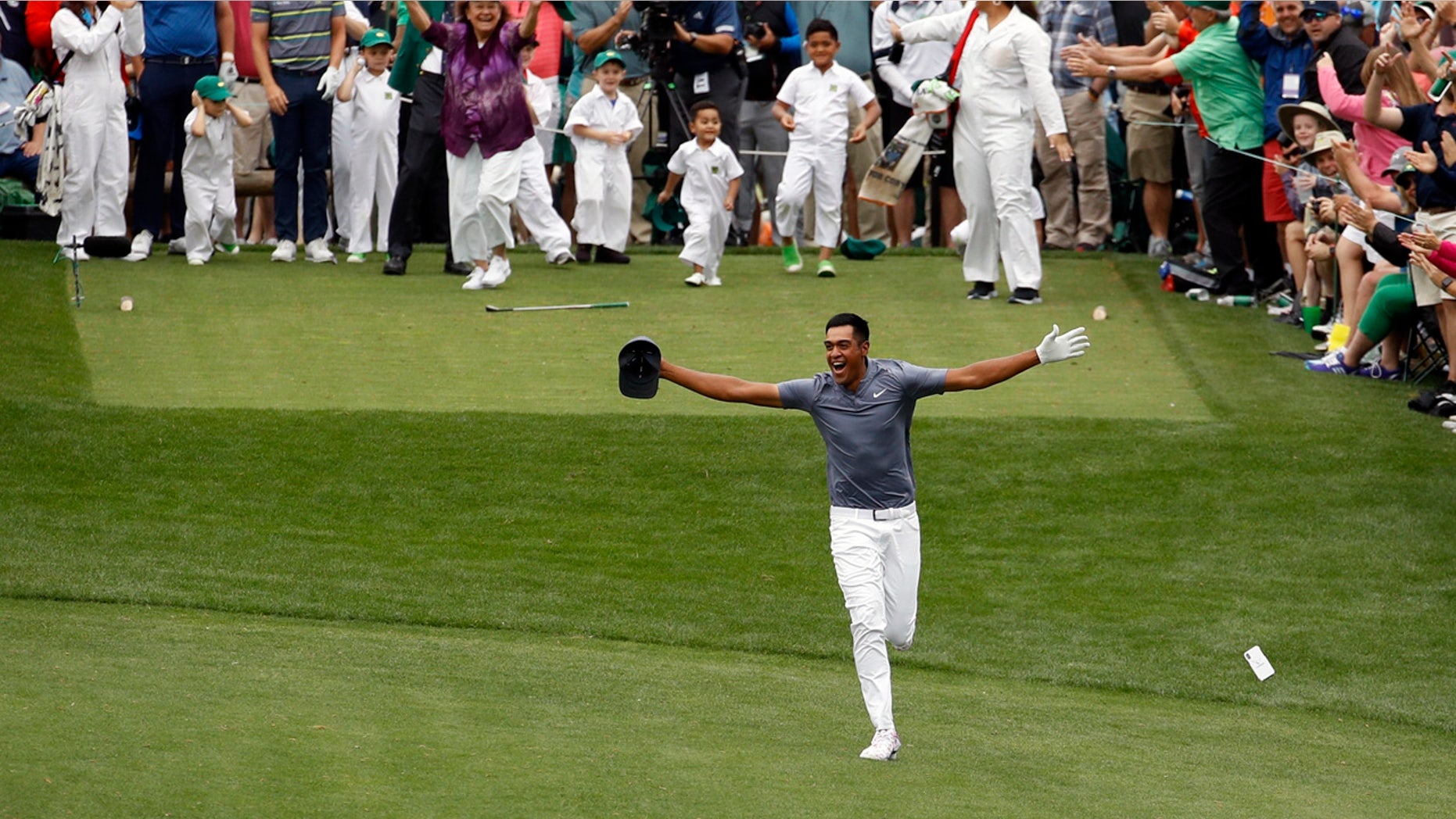 Tony Finau reacts to his hole-in-one at the Masters Par-3 contest seconds before turning his ankle Wednesday.