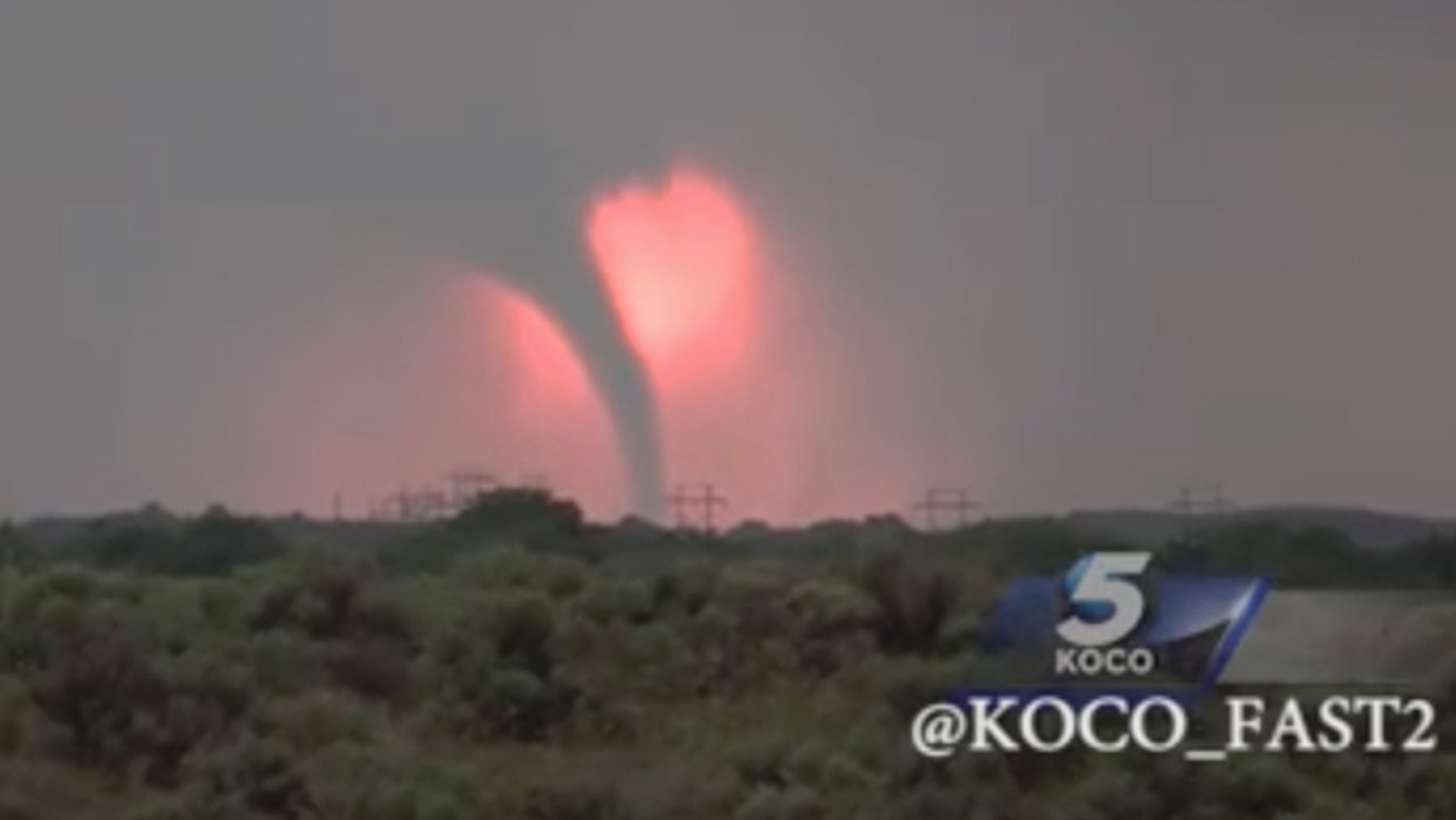 In this Monday, May 23, 2016 frame from video, a tornado moves through the area near Woodward, Okla., as the sun sets. (KOCO via AP) MANDATORY CREDIT