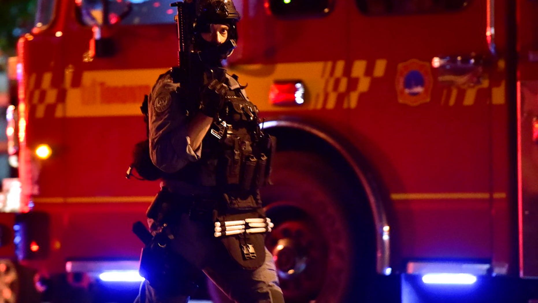 A tactical officer works the scene of a shooting, Sunday, July 22, 2018, in Toronto. (Frank Gunn/The Canadian Press via AP)
