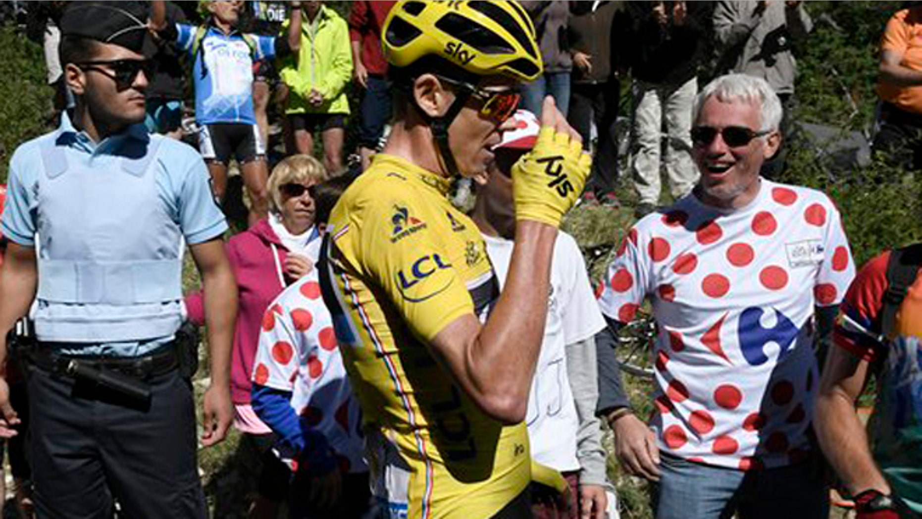 Britain's Chris Froome, wearing the overall leader's yellow jersey reacts after he crashed at the end of the twelfth stage of the Tour de France cycling race Thursday, July 14, 2016. (Jeff Pachoud/ Pool Photo via AP)