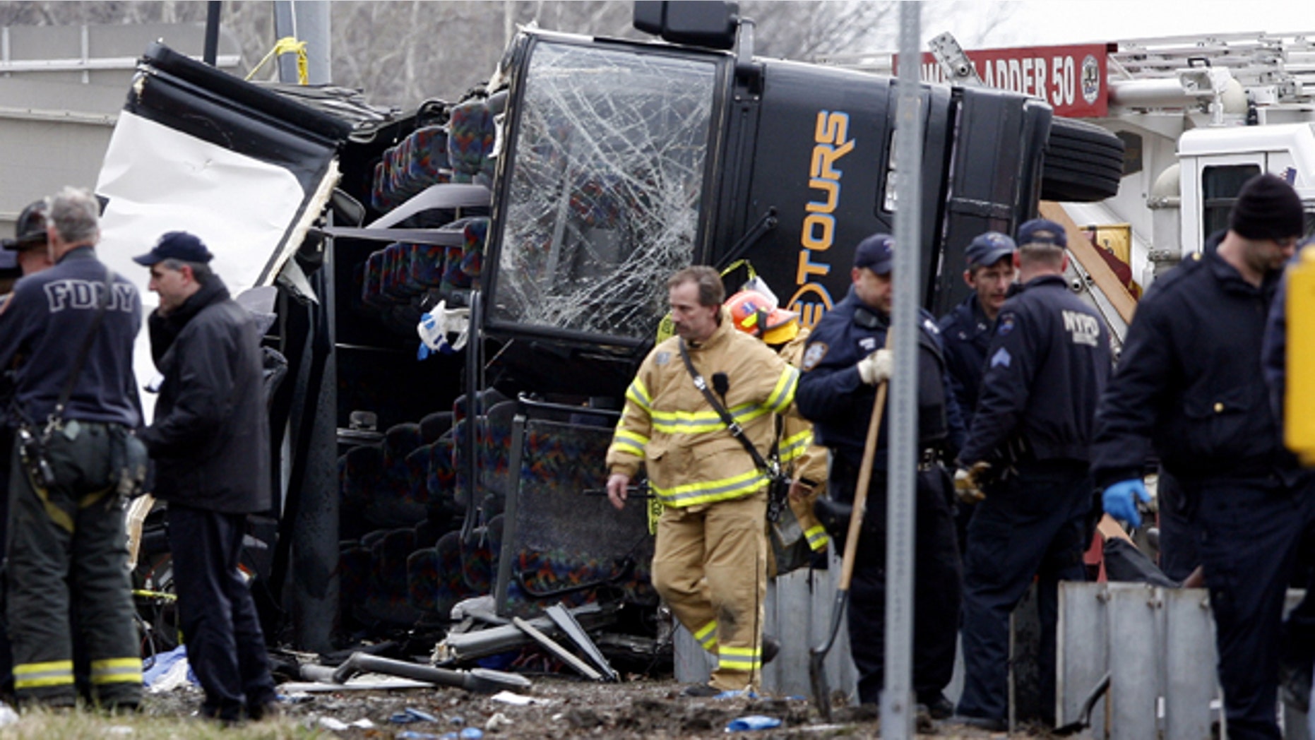 March 12, 2011: Emergency personnel investigate the scene of a bus crash on Interstate-95 in the Bronx borough of New York. Fifteen people died when the bus, returning to New York from a casino in Connecticut, flipped onto its side and was sliced in half by the support pole for a large sign.