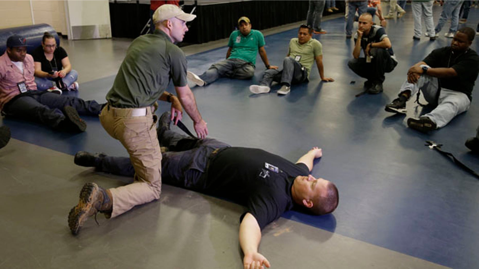 June 3, 2014: Houston police officer Austin Huckabee, left, uses officer Thomas Emmite, Jr, to show other officers how to apply a tourniquet at the police academy in Houston.