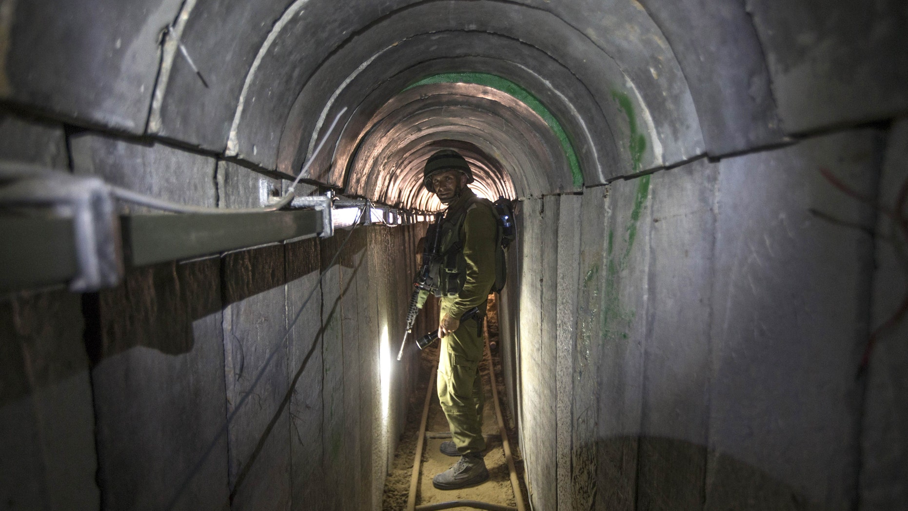 July 25, 2014: In this file photo, an Israeli army officer gives journalists a tour of a tunnel allegedly used by Palestinian militants for cross-border attacks, at the Israel-Gaza Border.