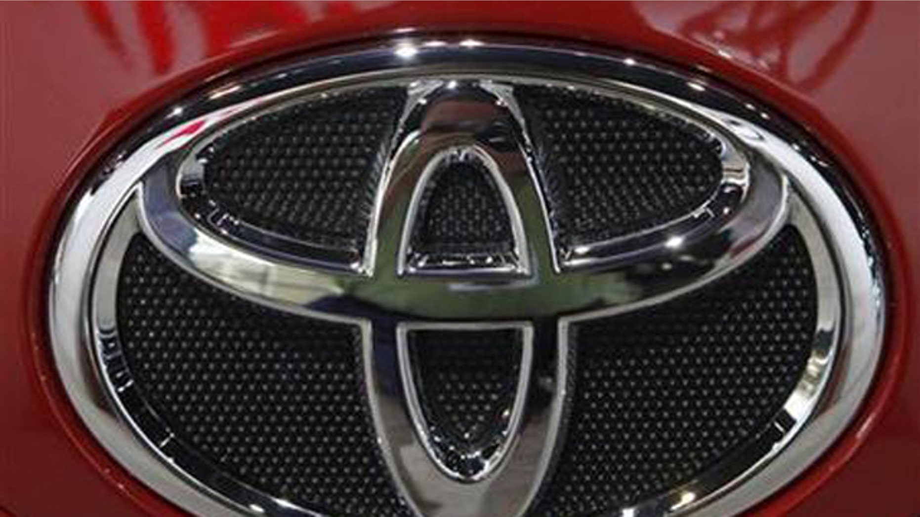 The Toyota emblem on a Camry is displayed during the first media preview day at the 2011 Chicago Auto Show in Chicago, Illinois February 9, 2011.