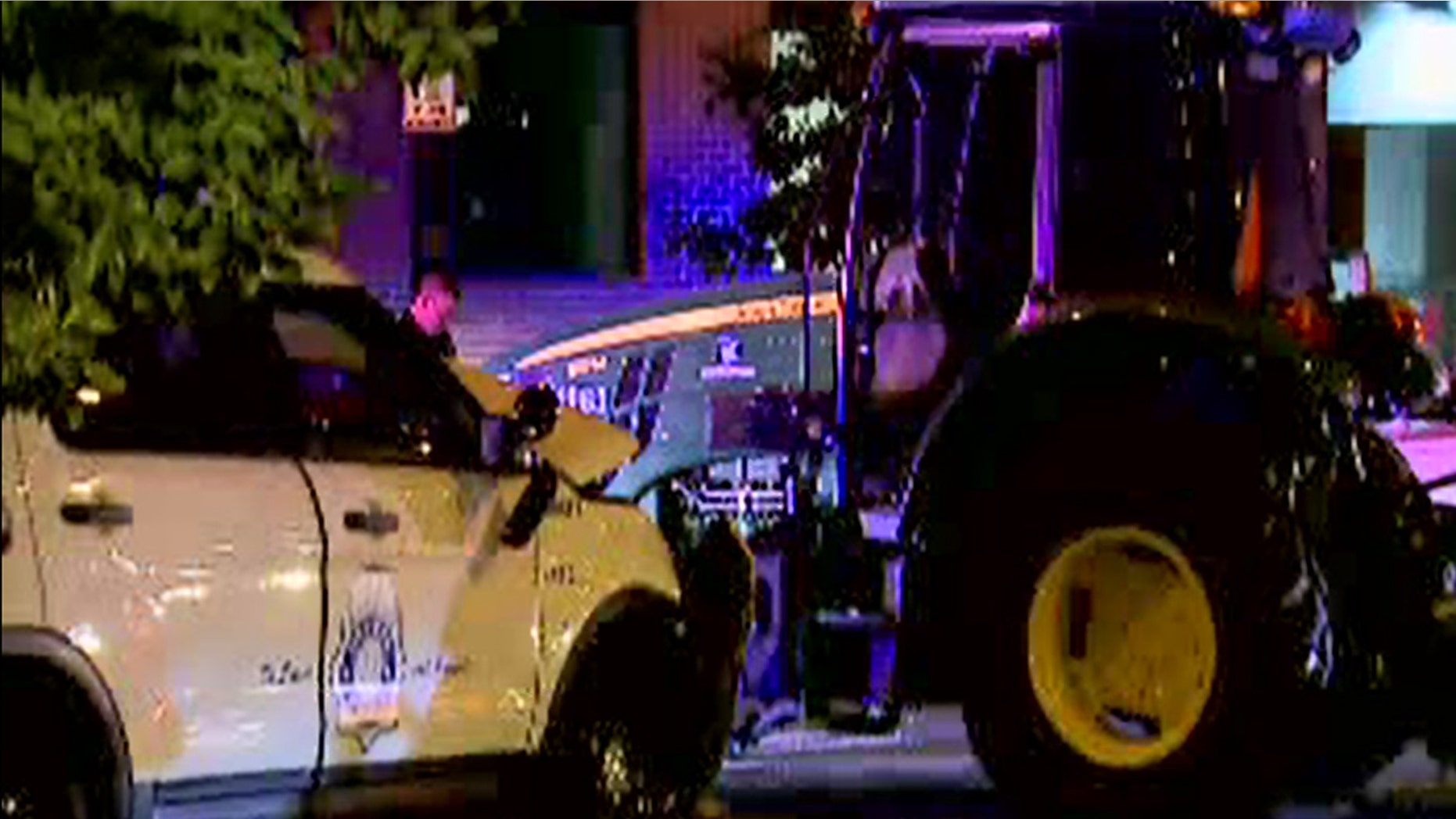 Two police officers were injured in a slow-speed chase with a John Deere tractor in downtown Denver on Friday night, police said.