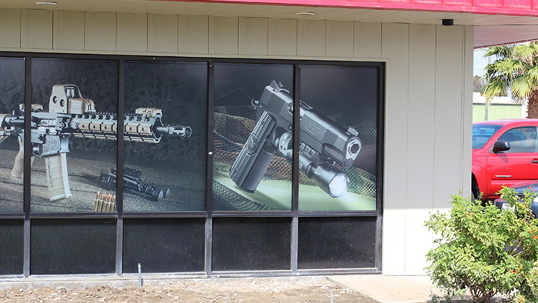 Michael Baryl, of Tracy Rifle & Pistol, has until February to take down this window display to comply with a Bureau of Firearms order. (Photo: Tracy Rifle and Pistol)