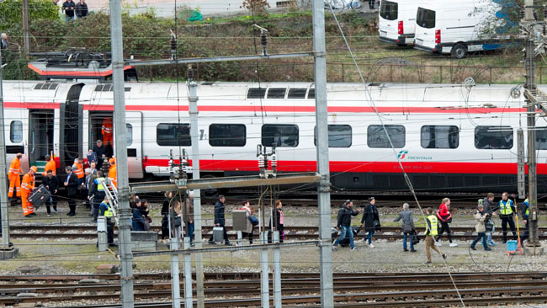 Rescuers help passengers next to a derailed train in the station of Lucerne, Switzerland, Wednesday, March 22, 2017. Swiss police say they are trying to reach people trapped inside the train in the city of Lucerne, with details of any injuries still unclear. Rail company SBB says the Milan to Basel train derailed Wednesday as it was pulling out of Lucernes main train station. (Urs Flueeler/Keystone via AP)