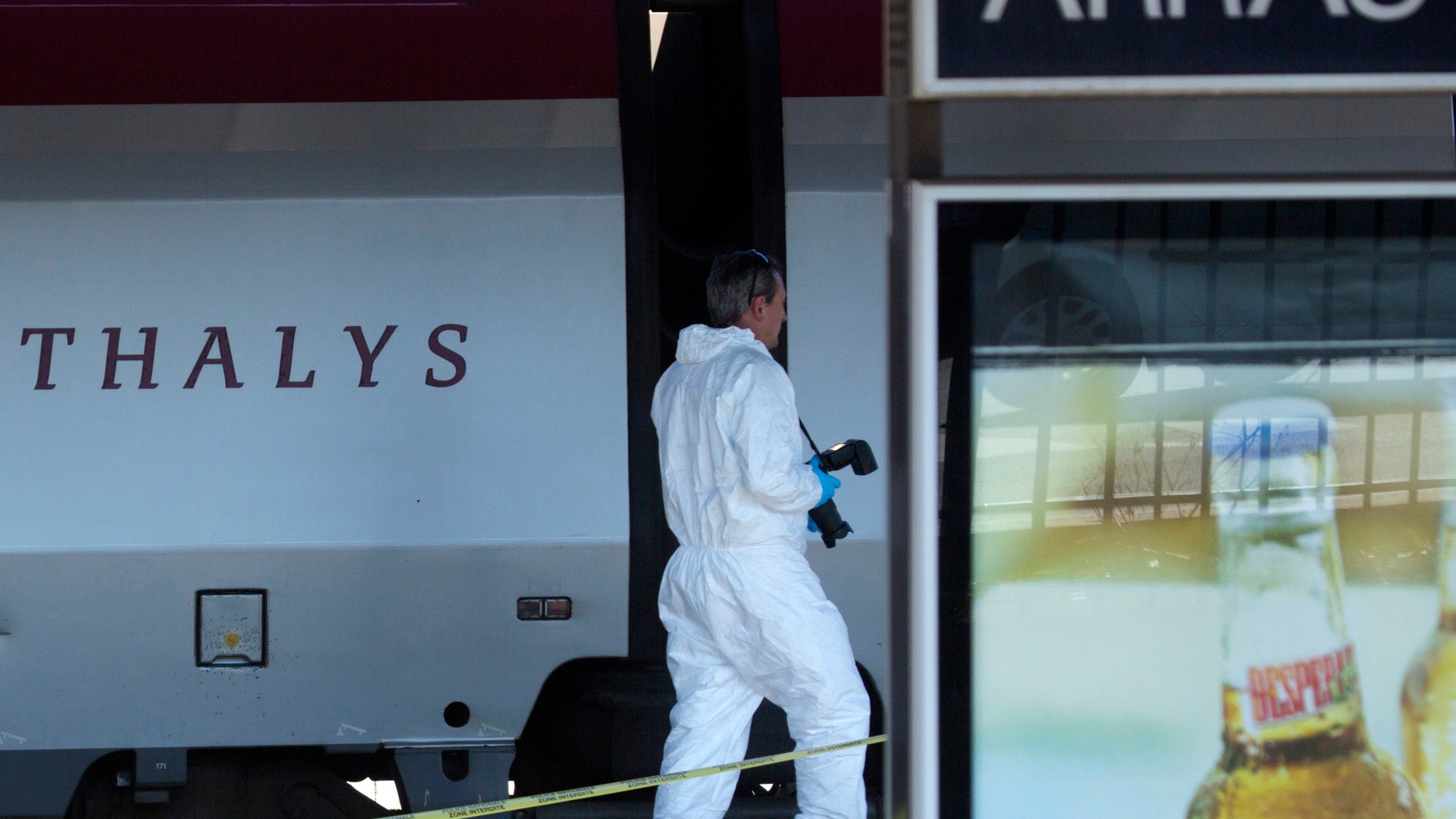 A member of the police forensics team investigates near a Thalys train on a platform at the Arras train station in northern France