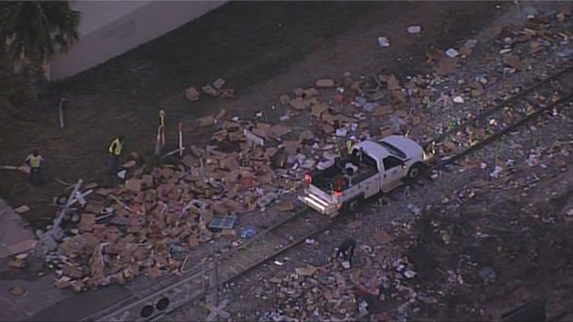 A train colliding with a semi-truck left boxes of meat scattered all over the roadway.