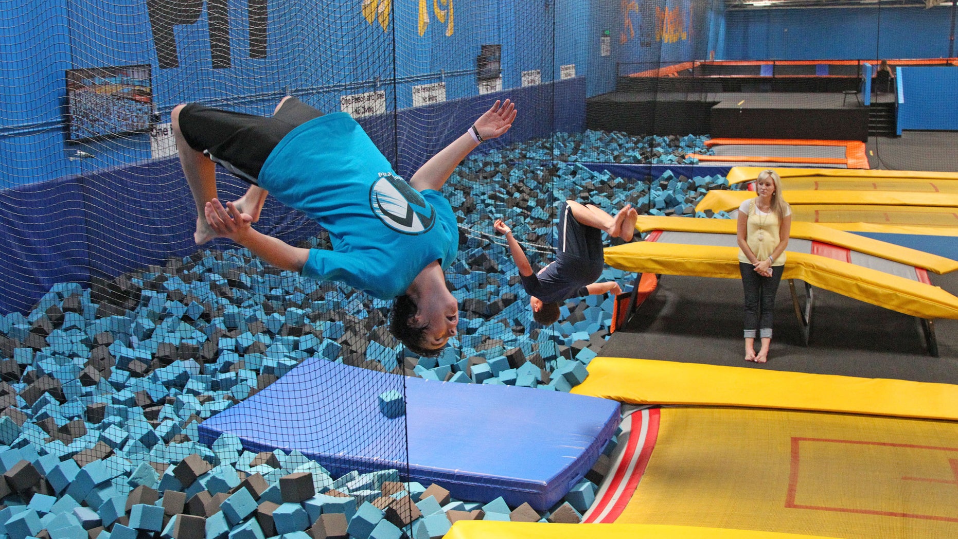 In this July 31, 2013, file photo, a patron flips at a trampoline park in Orem, Utah. Trampoline park injuries have soared as the indoor jumping trend has spread. That's according to a study published Monday, Aug. 1, 2016, that shows annual U.S. emergency room visits jumped 12-fold for park-related injuries from 2010 through 2014. (AP Photo/Rick Bowmer, File)