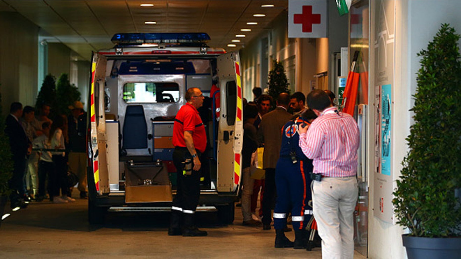 PARIS, FRANCE - JUNE 02: An ambulance waits to transport an injured spectator to hospital after a piece of the scoreboard above Court Philippe Chatrier was blown off in high winds during the men's singles quarterfinal match between Kei Nishikori of Japan and Jo-Wilfried Tsonga of France on day of the 2015 French Open at Roland Garros on June 2, 2015 in Paris, France. (Photo by Dan Istitene/Getty Images)