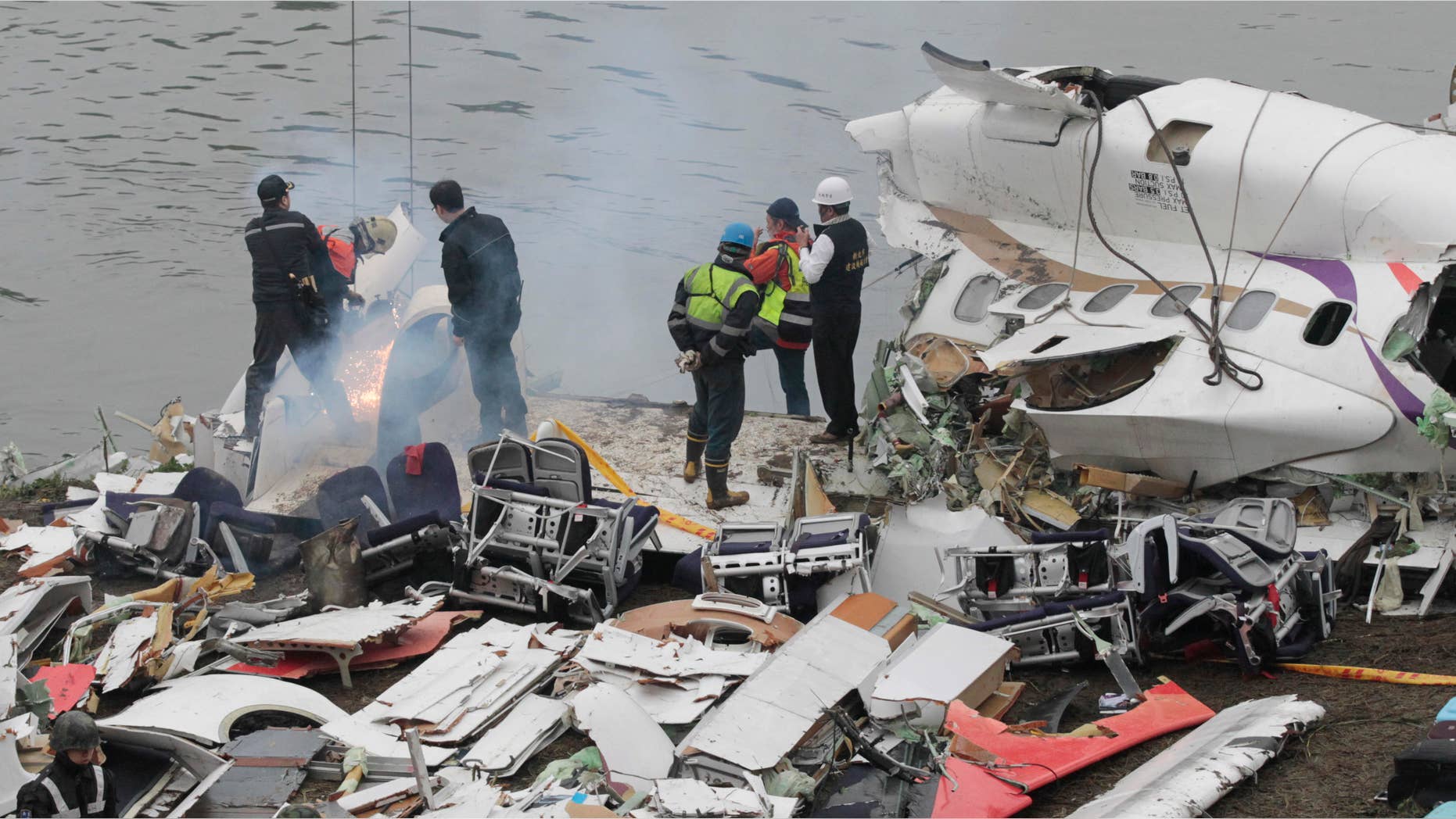 Feb. 5, 2015: Emergency teams break down pieces of wreckage at the site of a commercial plane crash in Taipei, Taiwan.