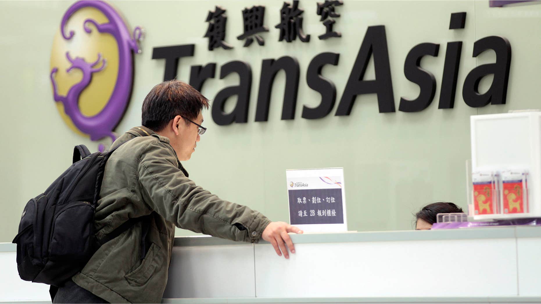 Feb. 7, 2015: A passenger waits at the ticket counter of TransAsia Airways at the Songshan Airport in Taipei, Taiwan.