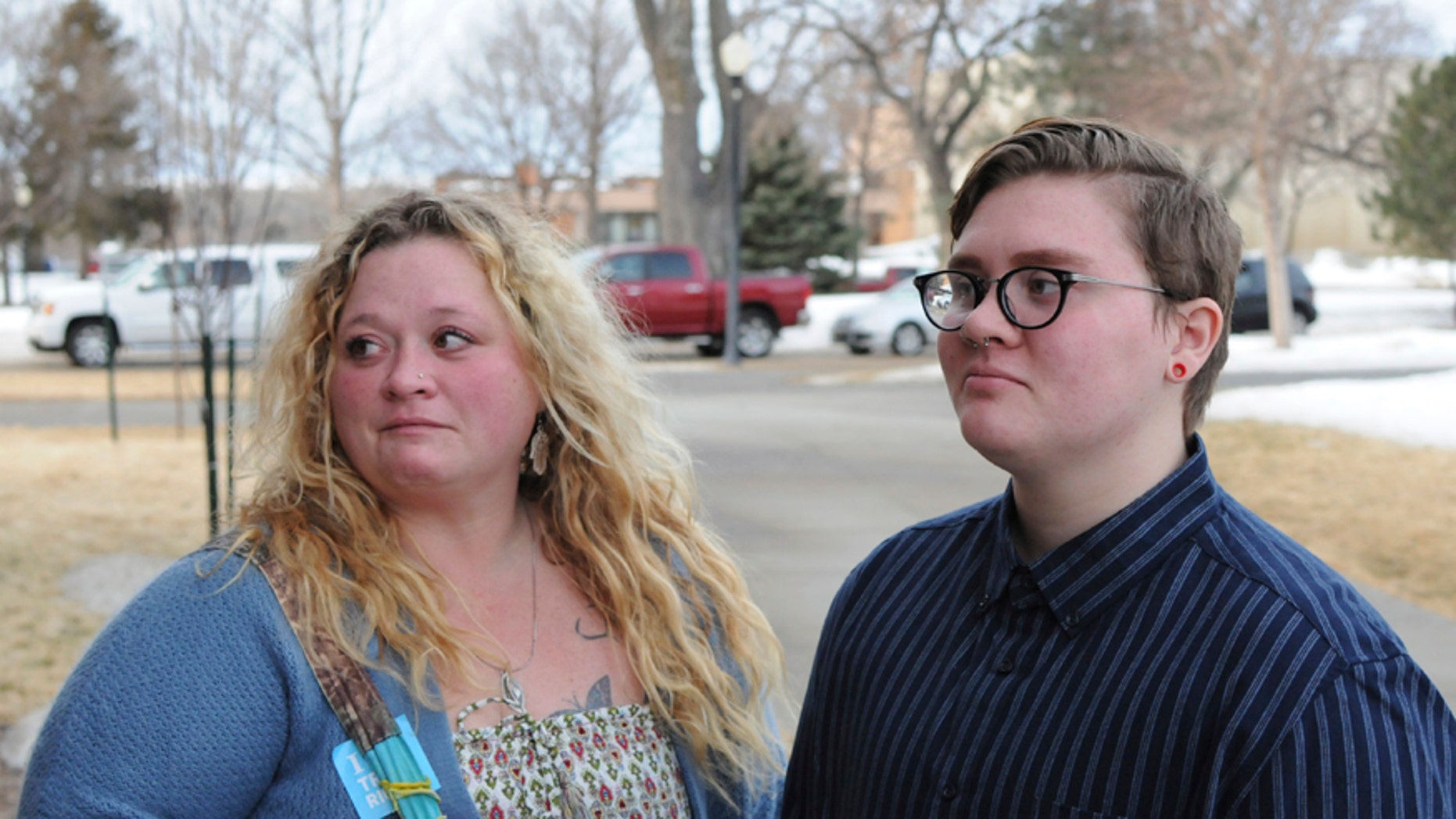 Jessie Lamphere, a transgender high school student, stands with his mom, Tyler Lamphere, left, after a brief hearing at the state Capitol in Pierre, S.D., Tuesday, Jan. 31, 2017. A bill that would have restricted which locker rooms South Dakota transgender students could use was withdrawn Tuesday. (AP Photo/James Nord)