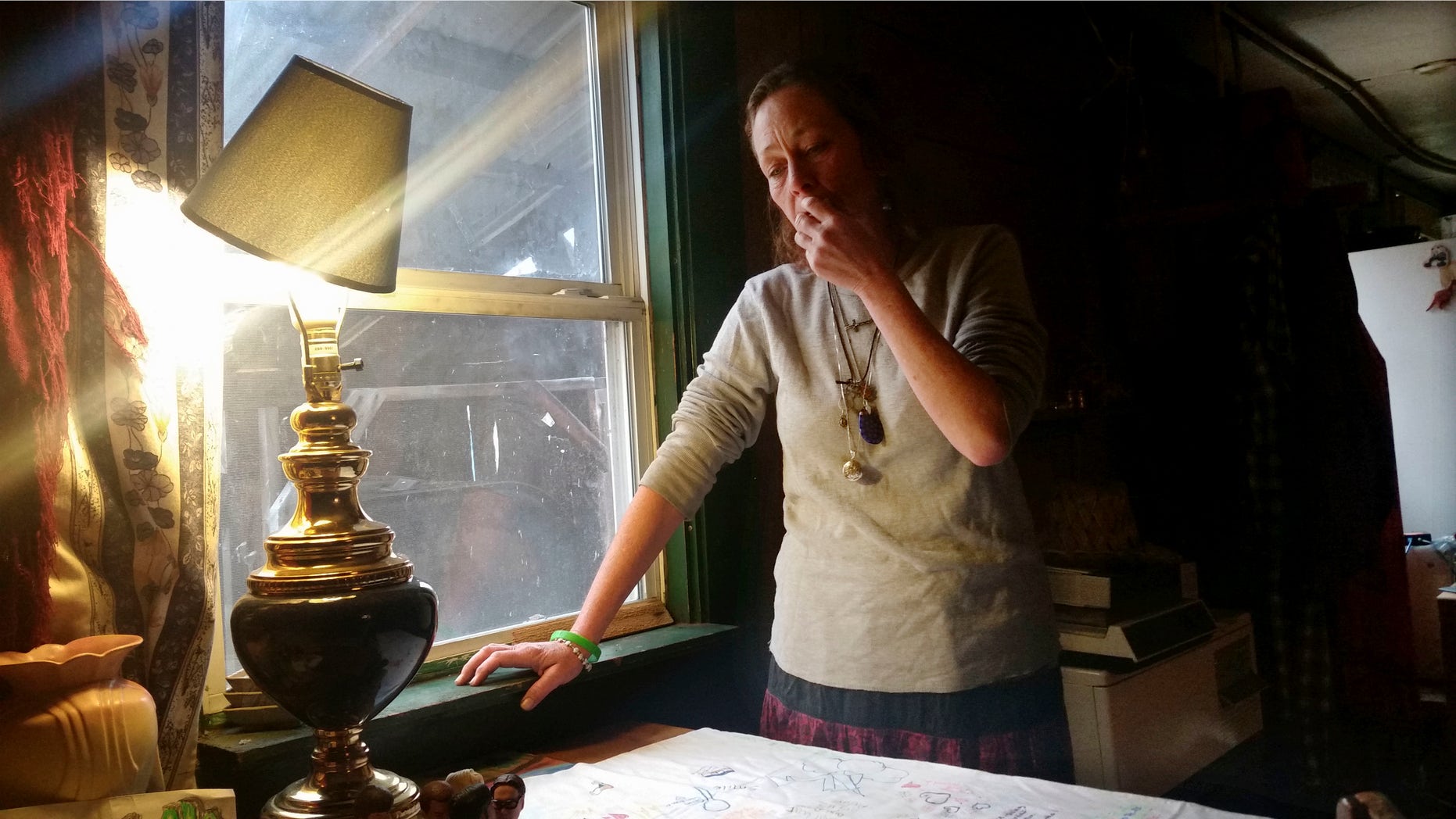 Michelle Knowles stands in her home Wednesday, Nov. 16, 2016, in North Vassalboro, Maine. Knowles is calling for more mental resources at juvenile detention facilities following her son Charles' suicide. Charles, a 16-year-old transgender boy who dreamed of being an LGBT activist, killed himself while temporarily detained at Long Creek Youth Development Center on Nov. 1, in South Portland, Maine. Family members say he was denied mental health care. (AP Photo/Marina Villeneuve)