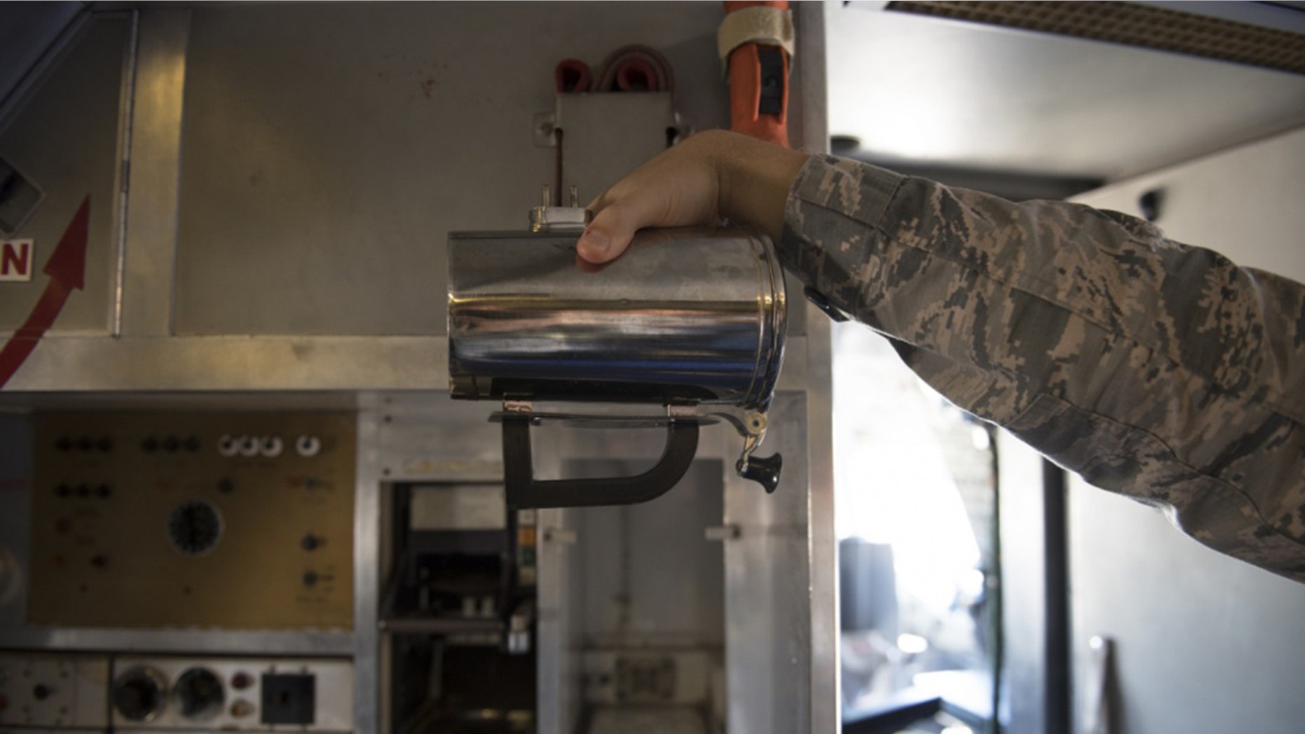 An Airman holds a hot cup inside a KC-10 Extender at Travis Air Force Base, Calif., in June.