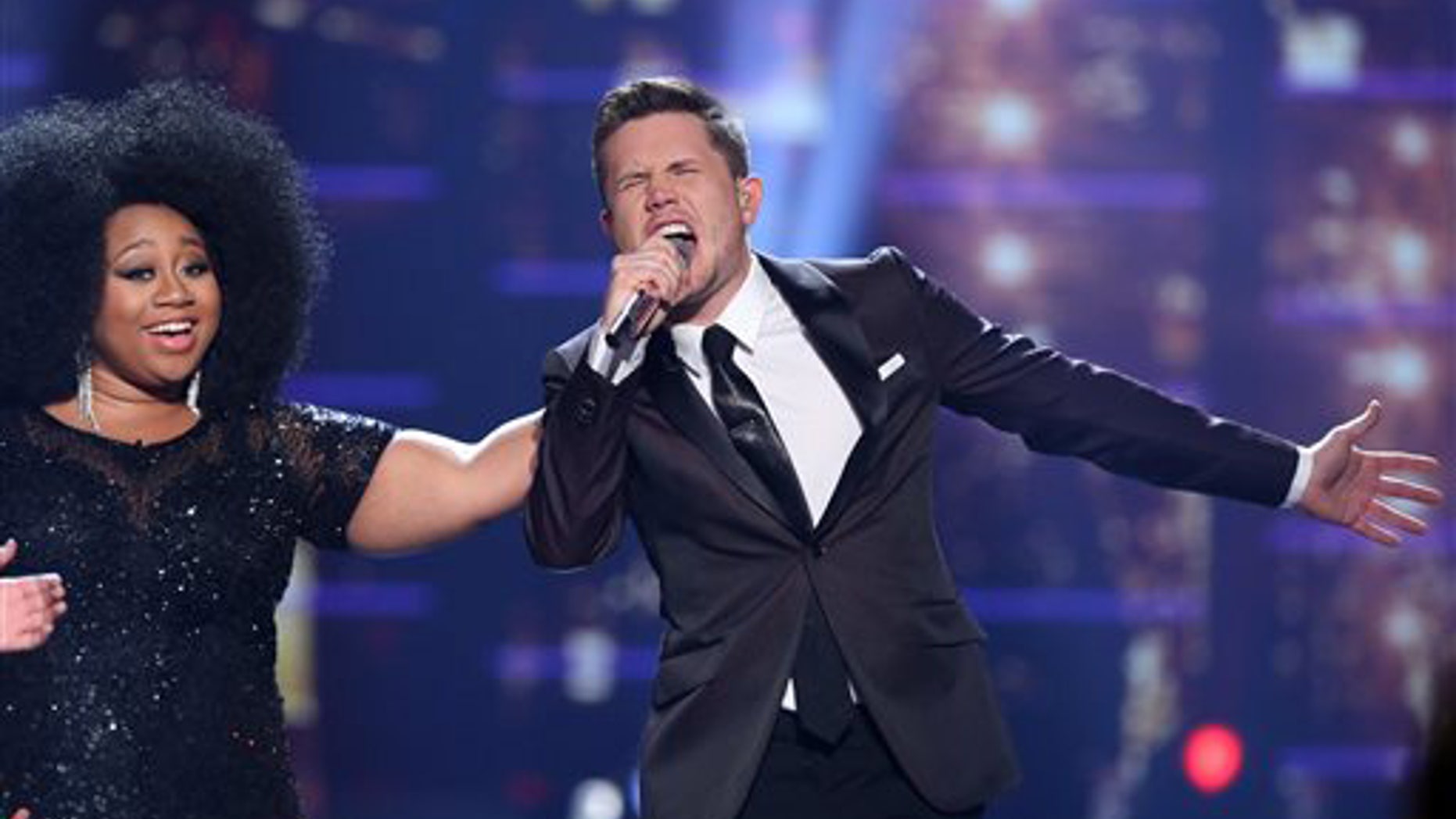 Winner Trent Harmon, right, performs at the "American Idol" farewell season finale at the Dolby Theatre on Thursday, April 7, 2016, in Los Angeles. Looking on from left is La'Porsha Renae. (Photo by Matt Sayles/Invision/AP)