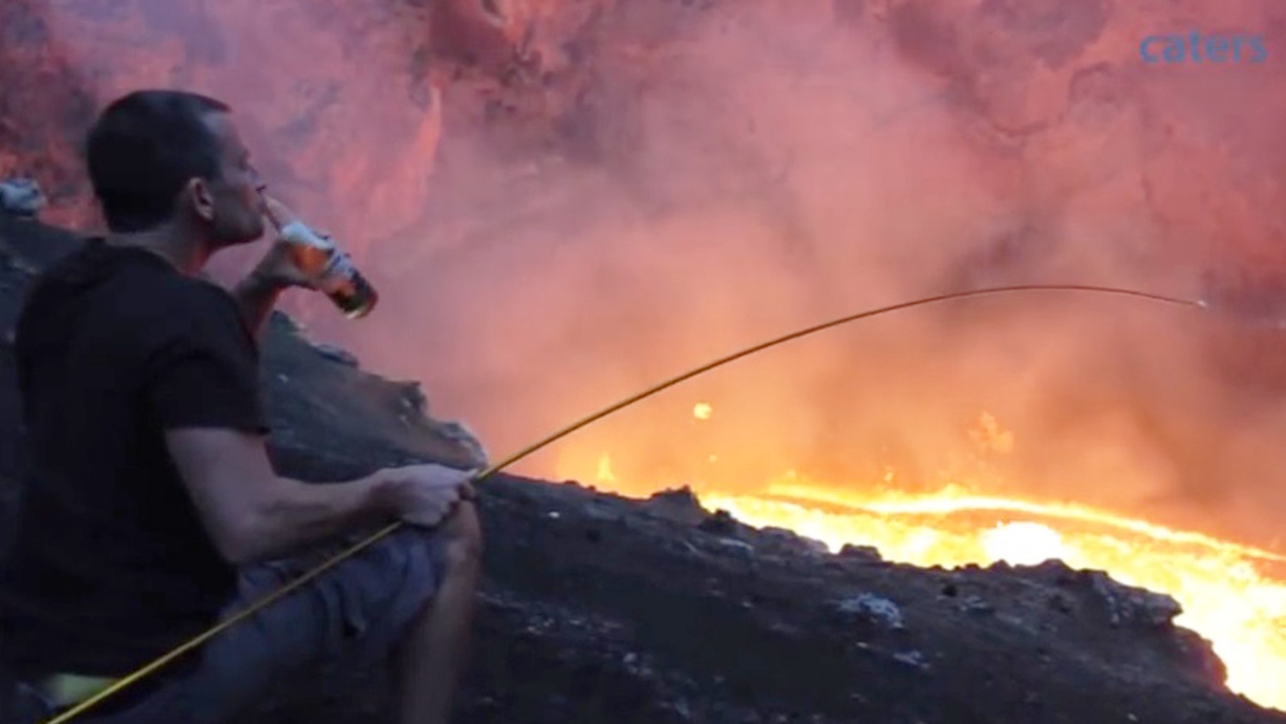 Simon Turner sits by an active lava lake to roast a marshmallow.