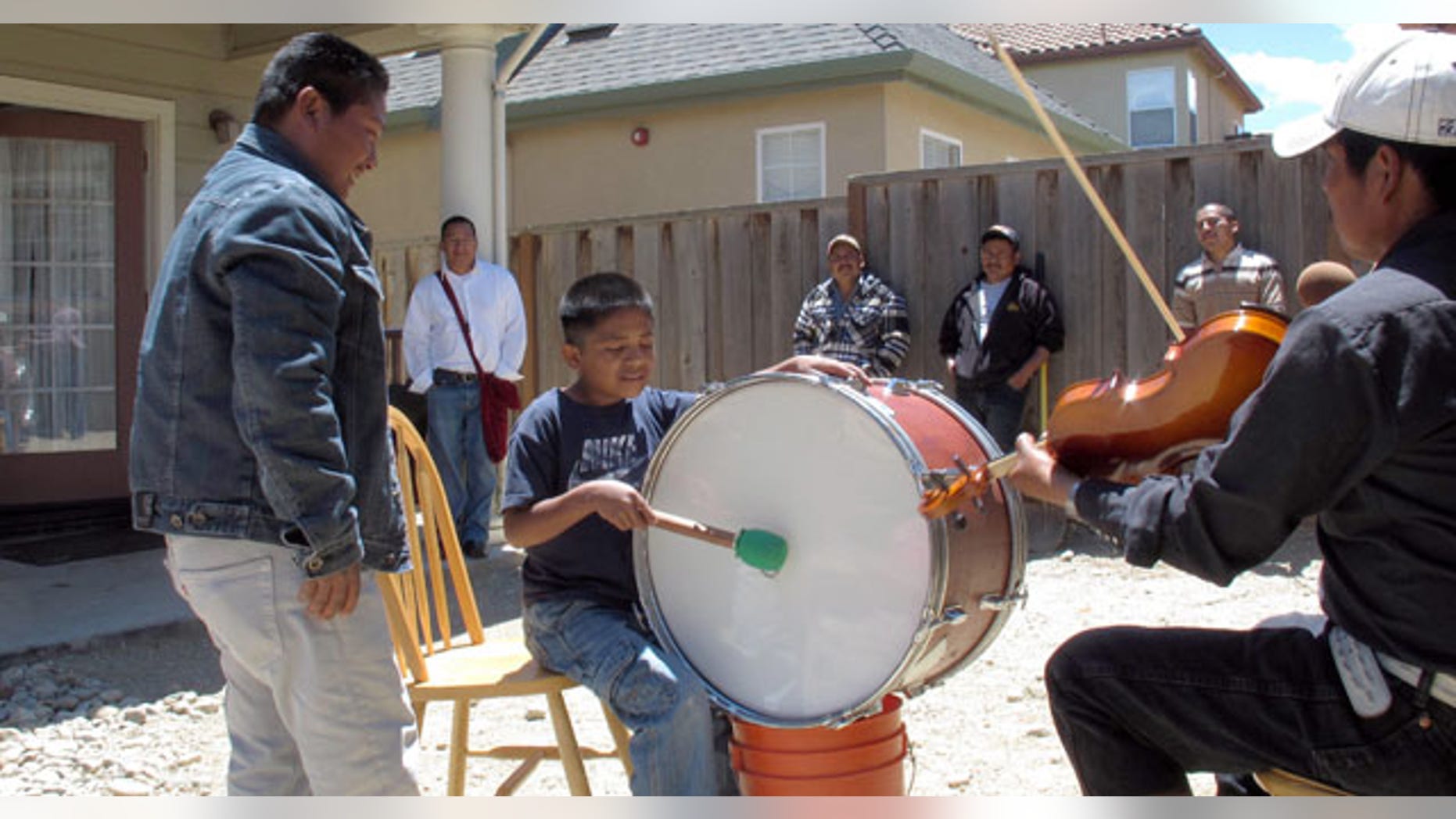 n this May 30, 2011 photo, Trique Indian children, whose families migrated from the Mexican state of Oaxaca, learn how to play traditional instruments at a community get-together in Greenfield, Calif. (AP Photo/Gosia Wozniacka)